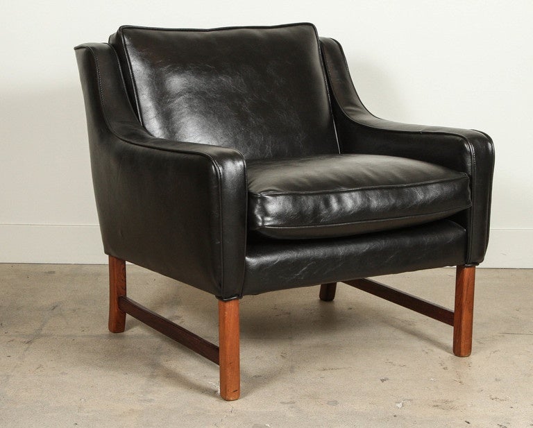 Pair of rosewood club chairs by Frederik Kayser for Vatne Mobler. Chairs feature black upholstery. Slight variations in wood tone between chairs.