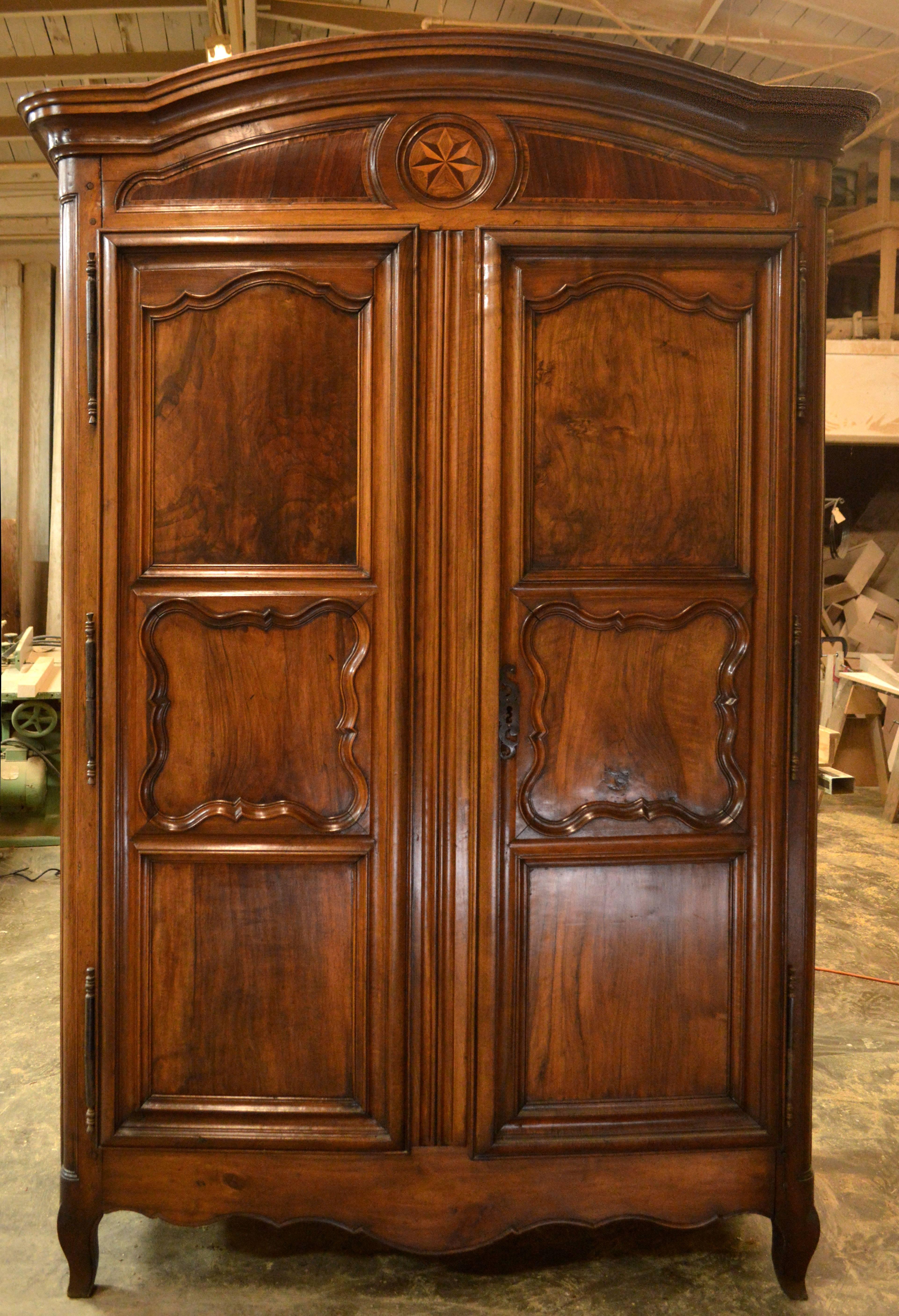 Excellent French Louis XV period armoire built with book matched panels. This is a monumental piece!