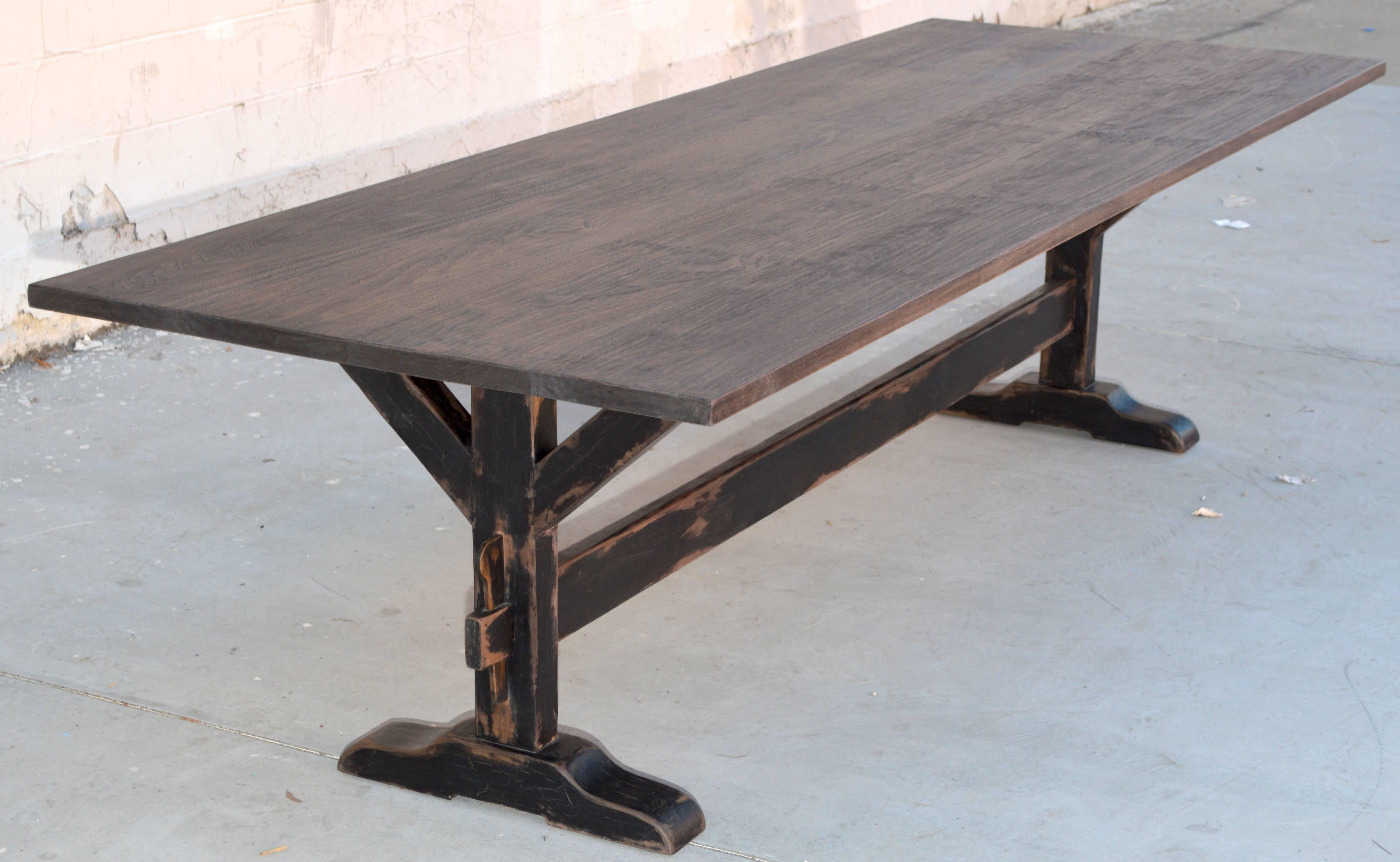 This distressed trestle table has a painted base and is made from vintage walnut. It is seen here 114