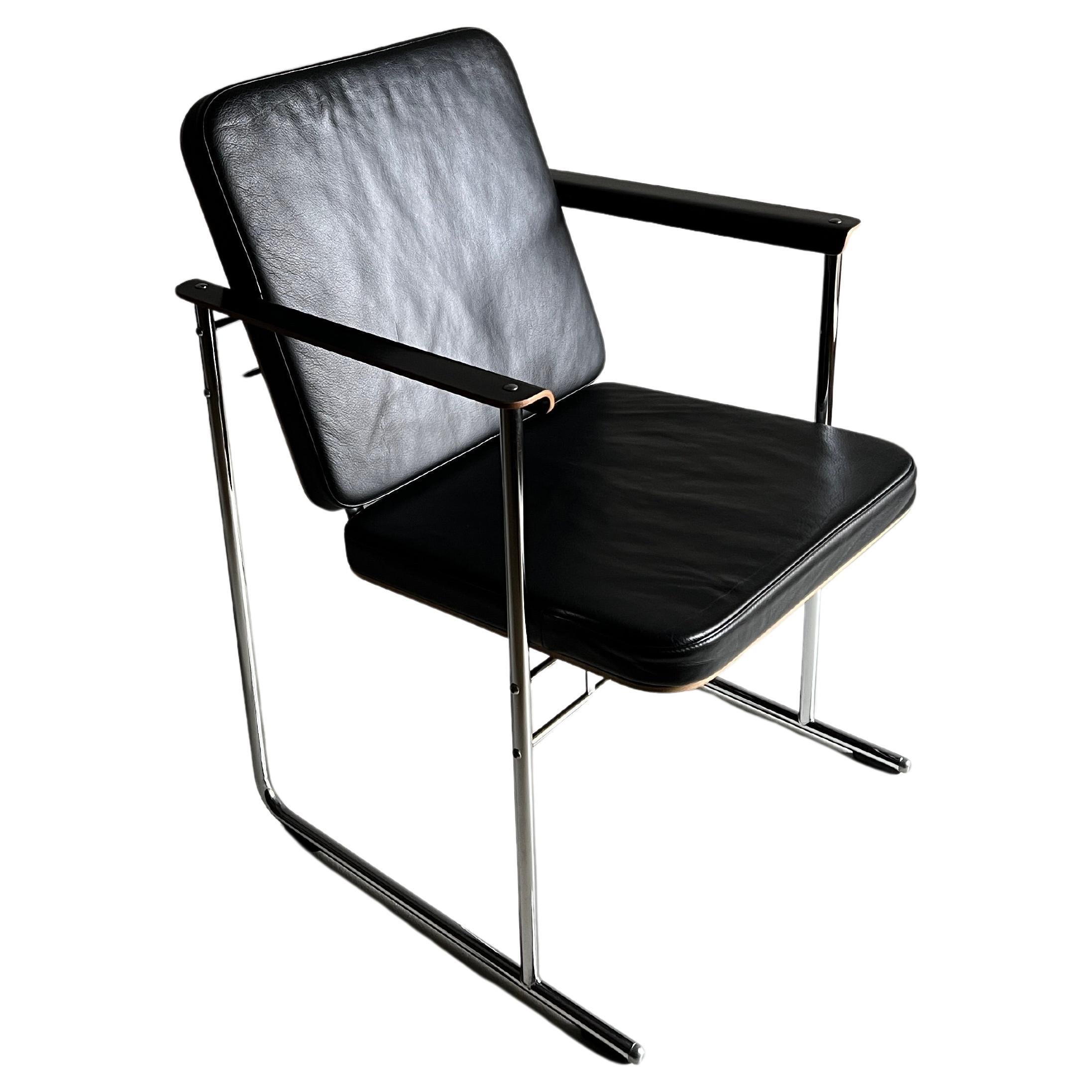 “Skaala” armchair designed by Yrjö Kukkapuro for Avarte. Laminated birch, chrome-plated tubular steel frame, high-quality black leather upholstery. 2 chairs are available.