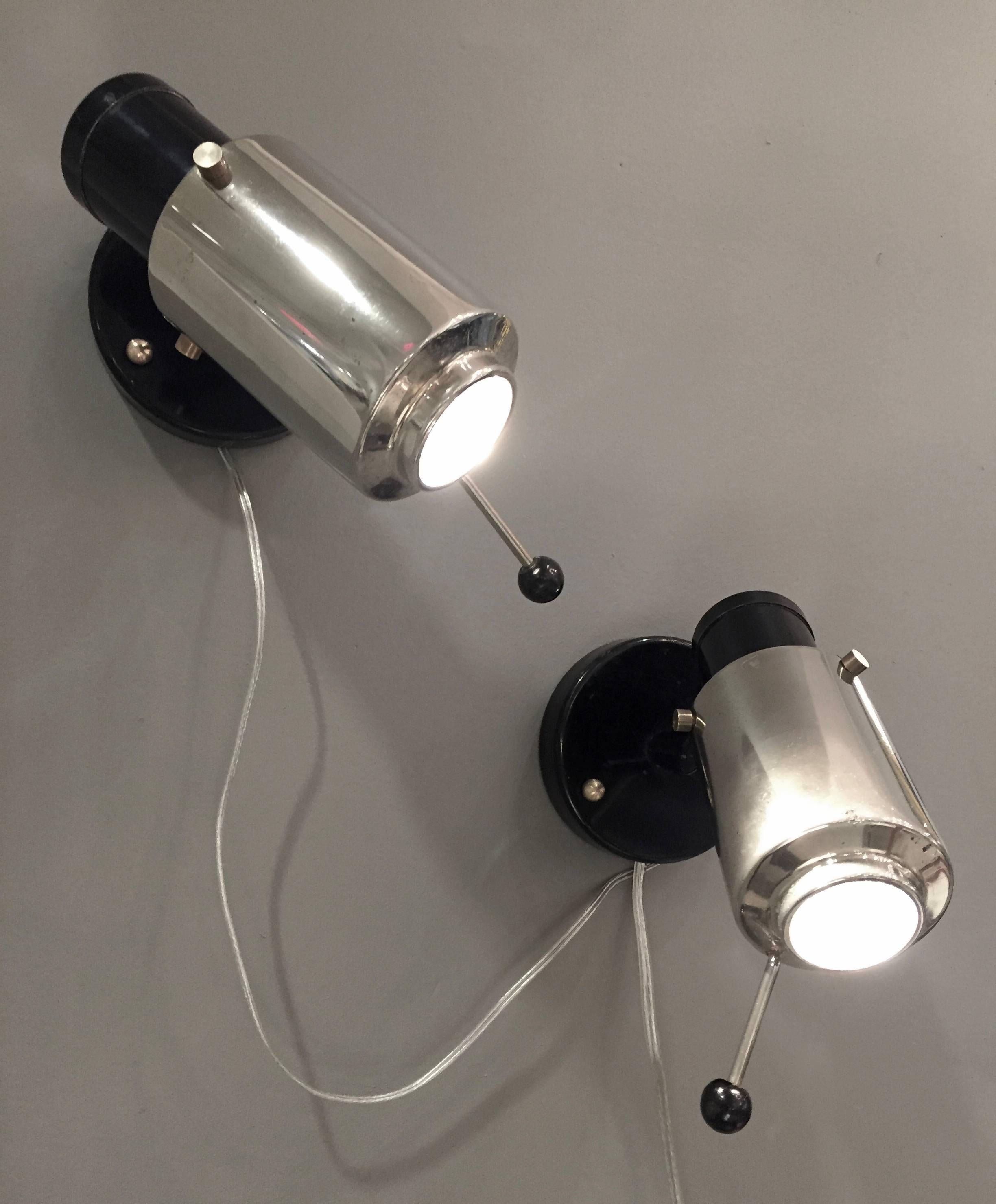 Adjustable sconce/reading lamps in polished nickel and black-painted steel and brass by Jacques Biny for Lita, circa 1960. Newly rewired for US usage and refuted with LED bulbs.