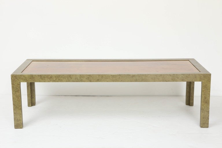 A simple Parsons-style table in rich olive lacquer with a faux-goatskin finish, the inset top in patinated solid brass. By John Widdicomb, 1960s, signed with metal plate to underside.