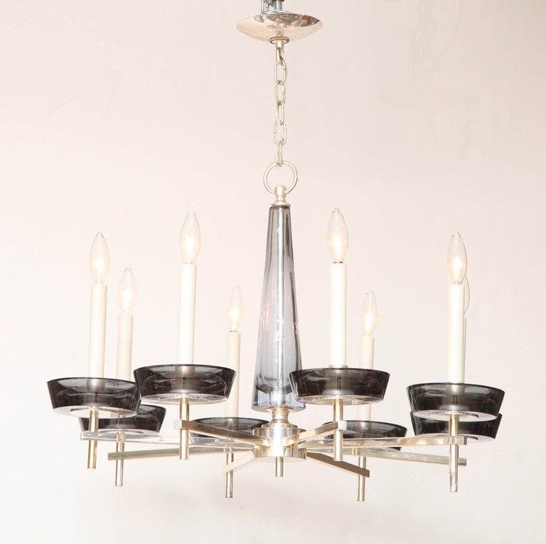 Eight arm chandelier in silver plated brass mounted with Murano glass candle cups and center shaft. By Salviati, ca 1960, in sommerso pale grey and alexandrite glass, changing in color from an ice- blue tinge in daylight to a pale grey-lavender at