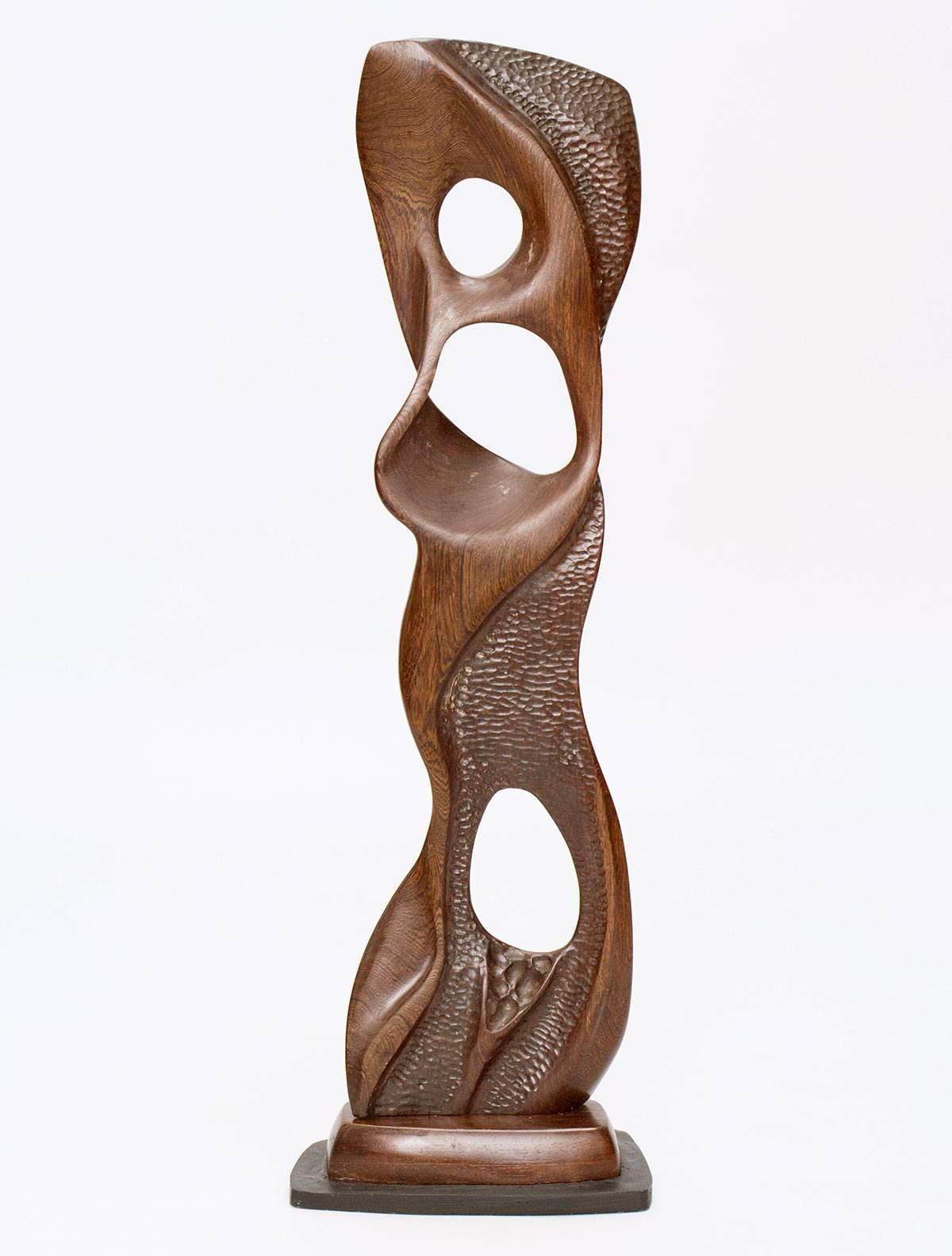 Expertly carved, biomorphic black walnut wood sculpture on artist’s stand by acclaimed New Hope, Pennsylvania sculptor E. Newell Weber. The liquid-like piece is finely textured on one side and smooth on the other. Partially signed.