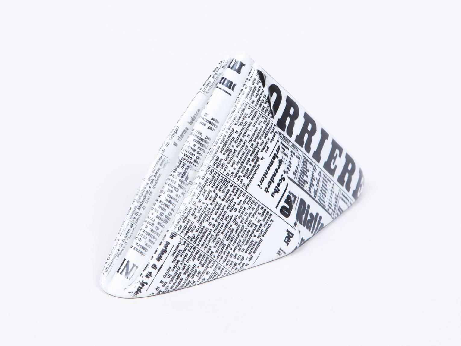 Porcelain paperweight in the form of a newspaper hat by iconic Italian artist Piero Fornasetti.