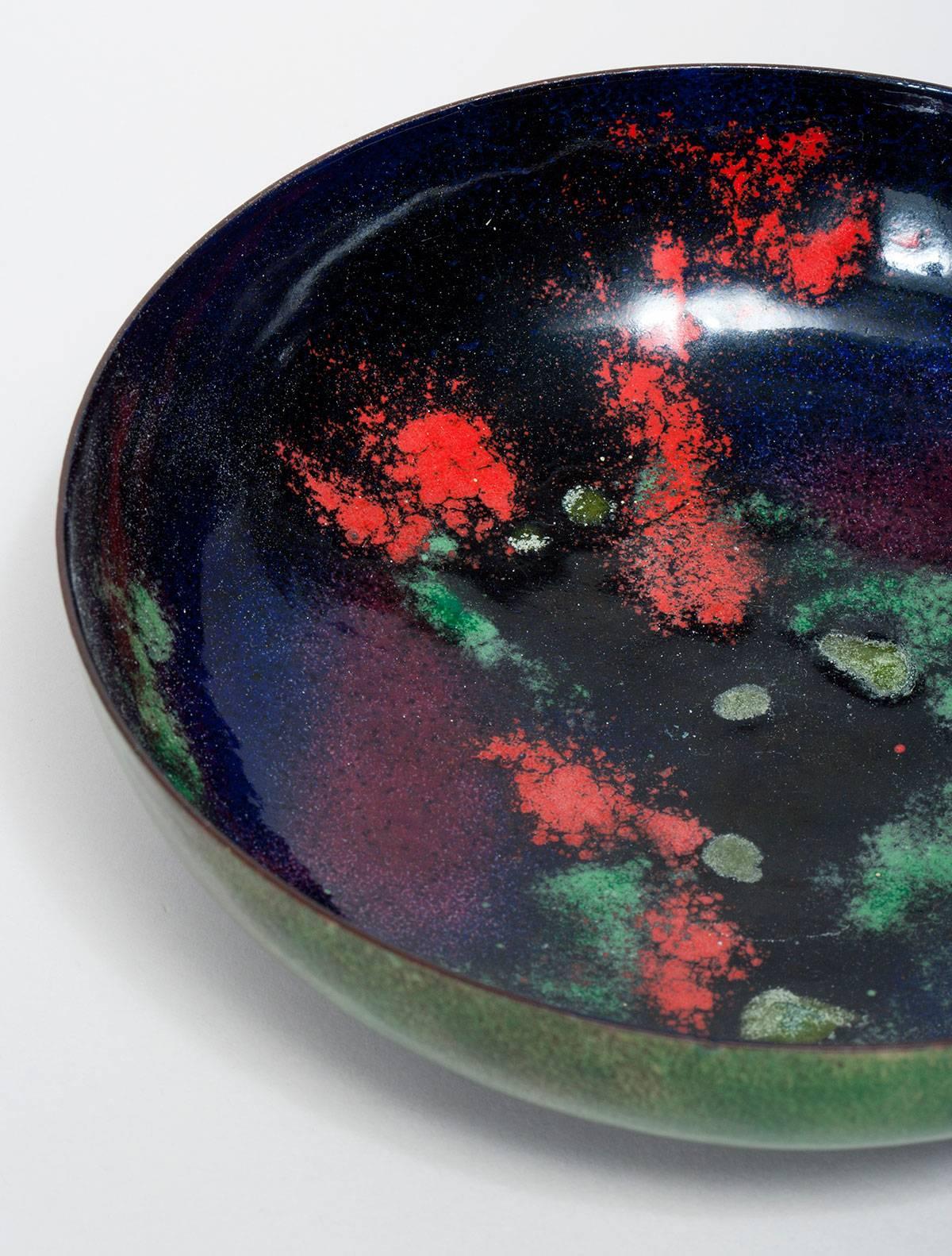 Large green enameled bowl with deep blue interior and red decoration designed by Paolo De Poli. Signed.