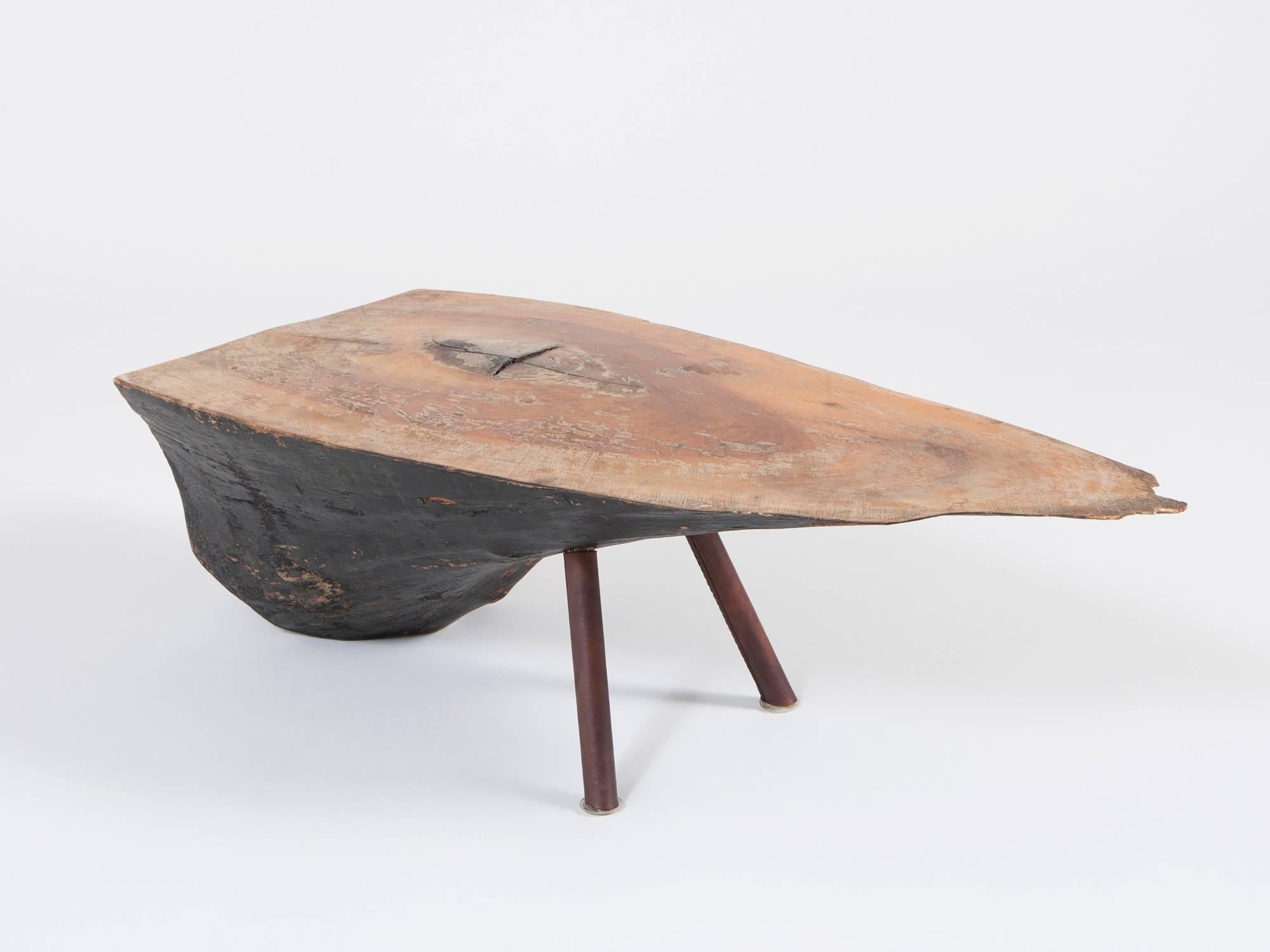 An exceptionally rare and early hand-made hewn log table with carved wooden top, painted bottom, and elegant leather-covered legs, by the Viennese design master Carl Auböck. In addition to the small objects that Auböck designed, his repertoire also