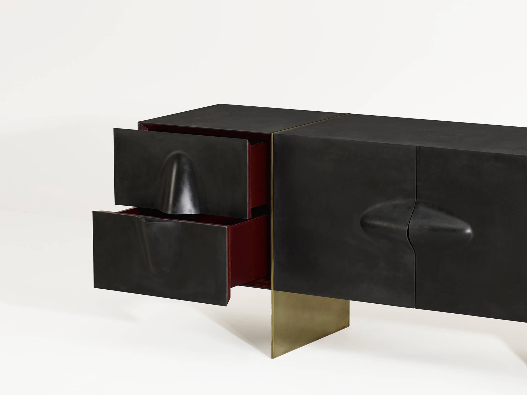 Beautiful rubber and brass credenza with an aniline dyed wood interior by  Brian Thoreen. Made to order in Los Angeles with a lead time of 10-12 weeks. Please inquire for custom sizing. Available with either a red, green, or black interior. 

 