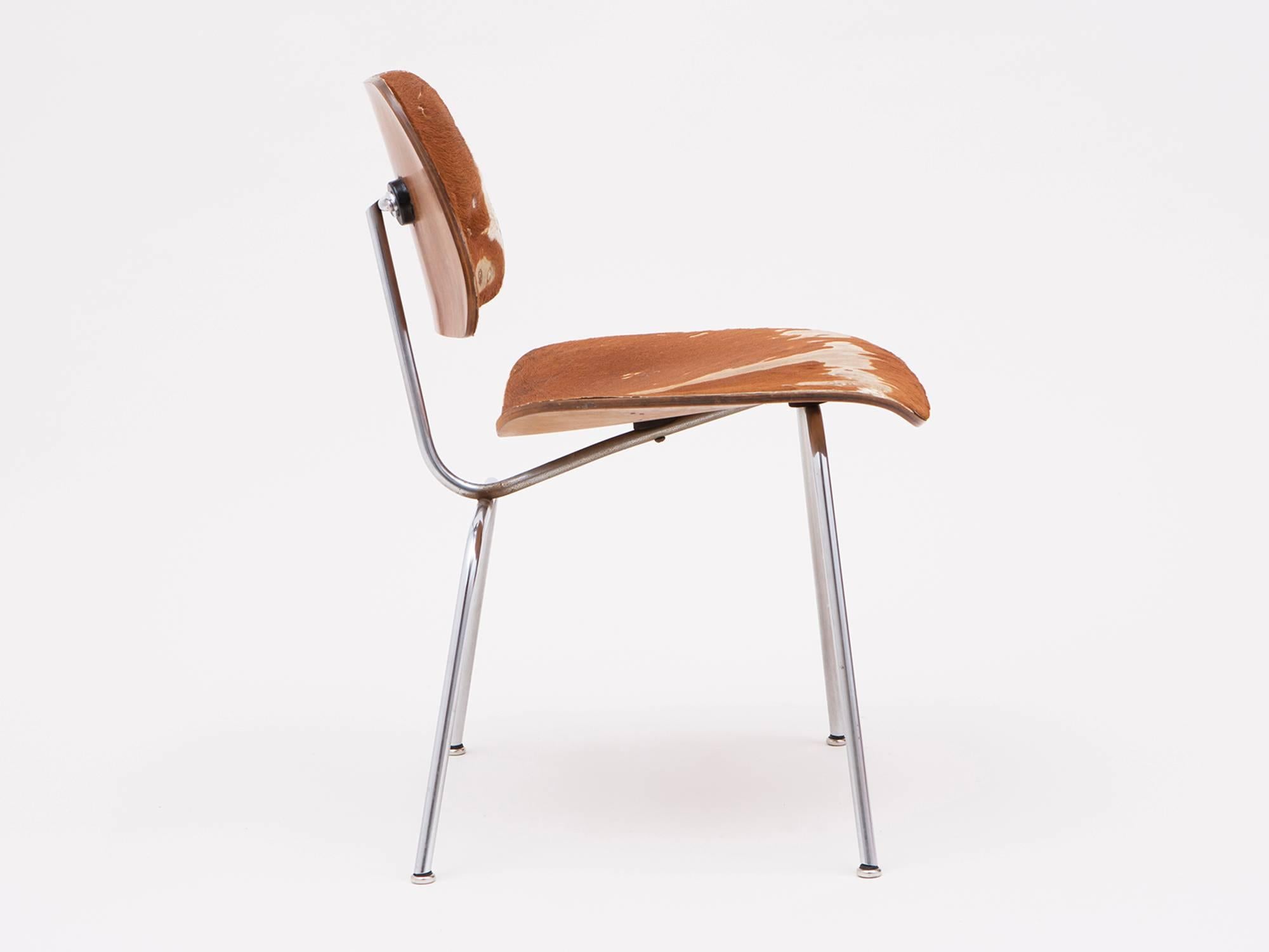 An early DCM dining chair, designed by Charles and Ray Eames and manufactured by Herman Miller, circa 1948. This chair is especially rare, made of ash plywood and steel with original slunk skin or fur upholstery.