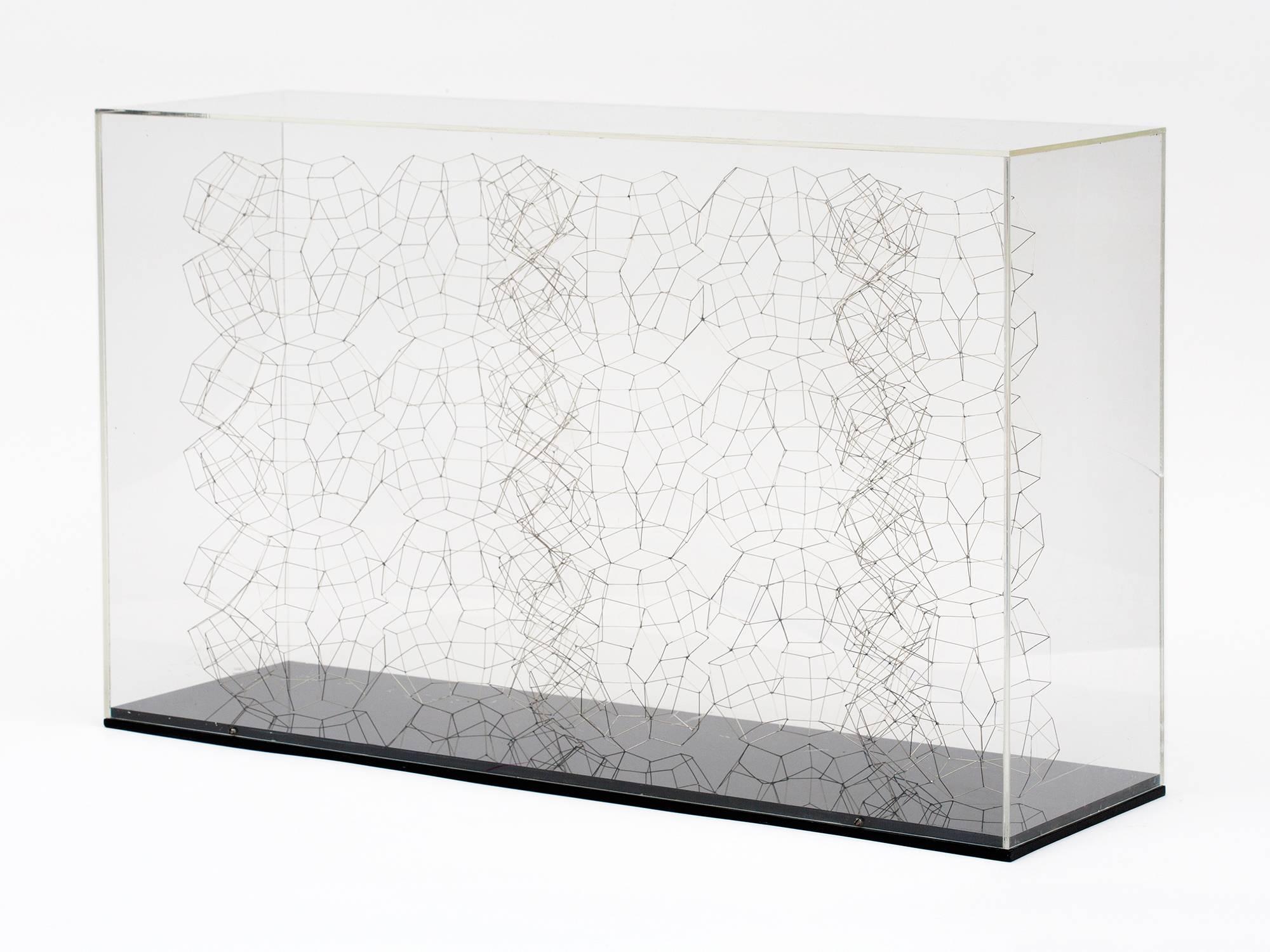 Intricate soldered wire geometric tabletop sculpture by Marilynn Gelfman-Karp, incased in a plexiglass box. Signed M. Gelfman Pereira. Marilyn Gelfman-Karp (b. 1939) is an American artist, gallerist, author and professor. An avid collector of