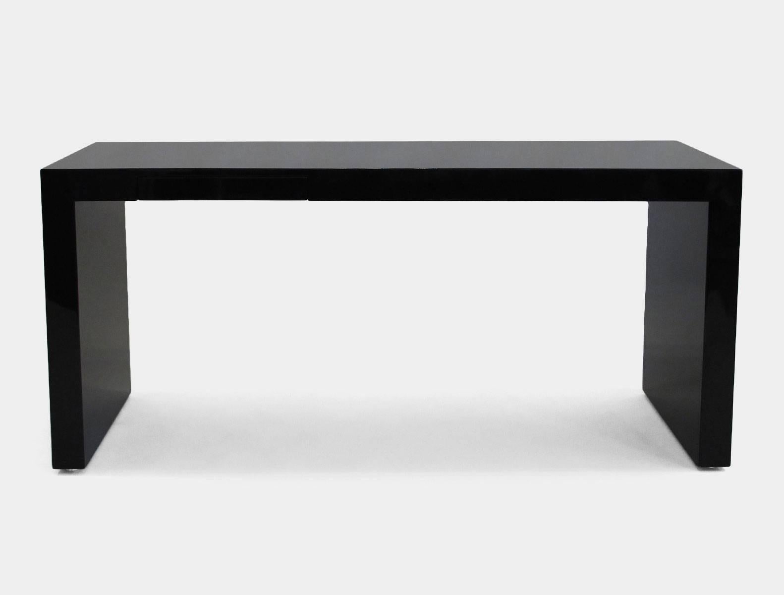 Large, smooth, black lacquered Monolith desk with a tiny and elegant hidden pencil drawer. Designed in the 1970s by Paul Mayen for Intrex Furniture of New York City.