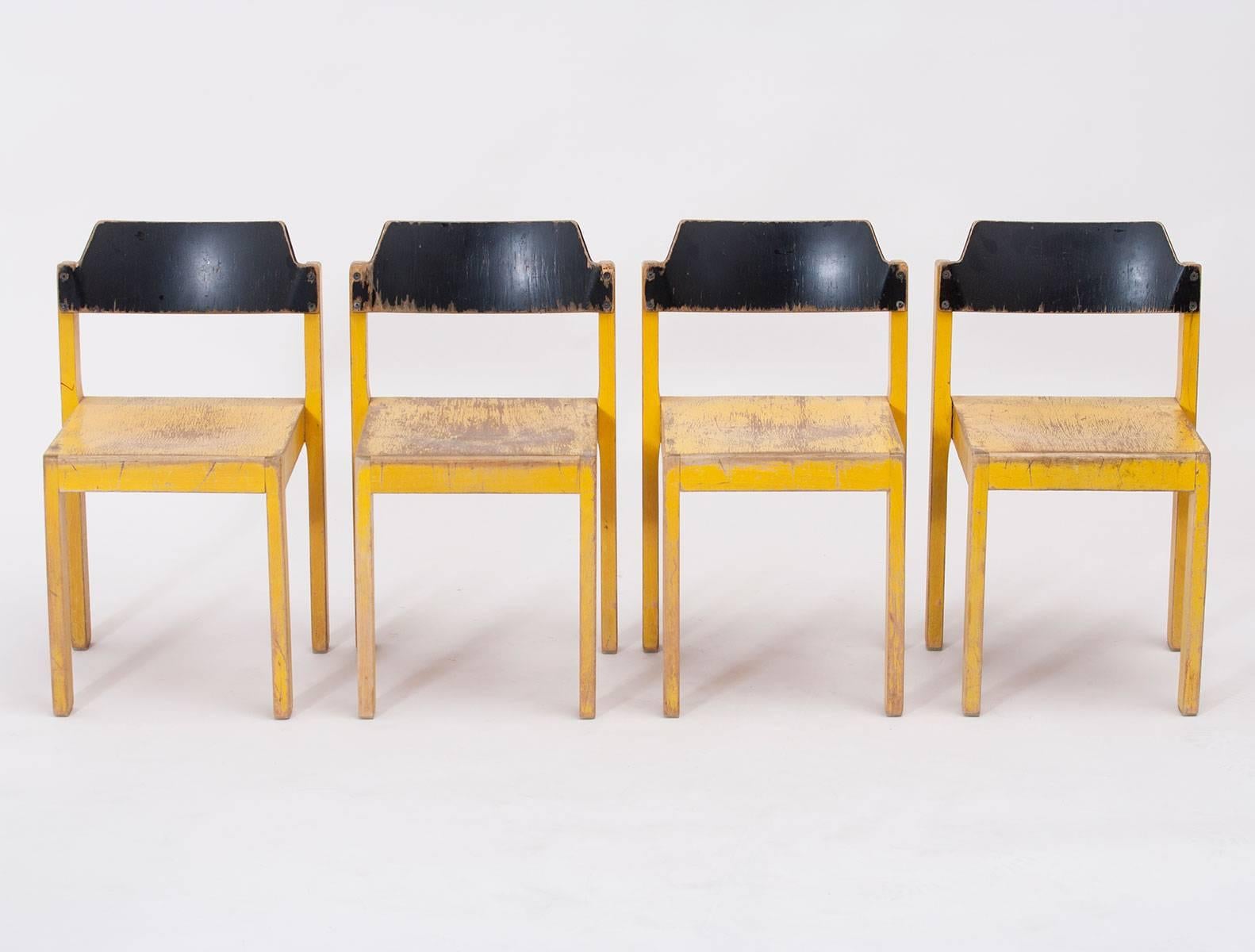 Set of four stacking wooden children's chairs, aniline-dyed osage yellow and black; well-constructed and beautifully aged. Made in Germany in the 1950s by an unknown designer.