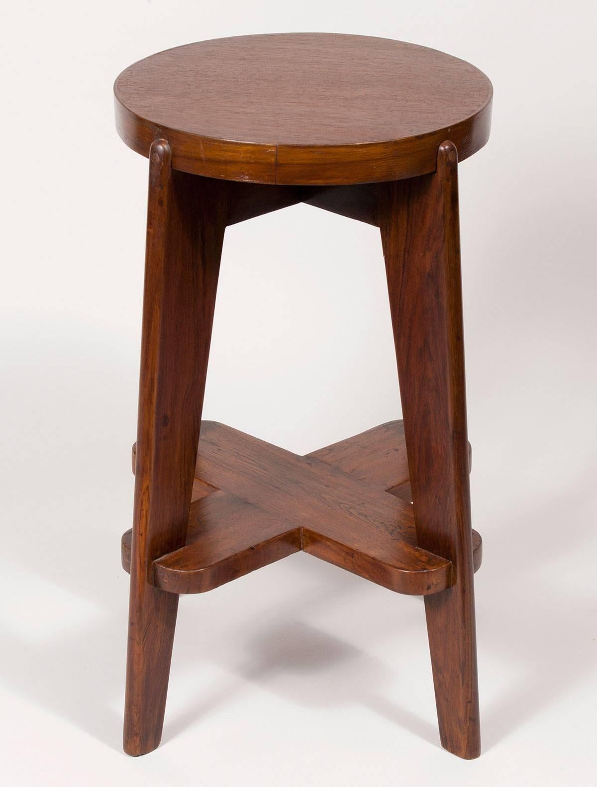 Solid Indian teak bar stool by the Swiss architect Pierre Jeanneret. The stool is an original from the Modernist city of Chandigarh, India, which he designed with his cousin Le Corbusier. In addition to its singular beauty, Jeanneret's Chandigarh