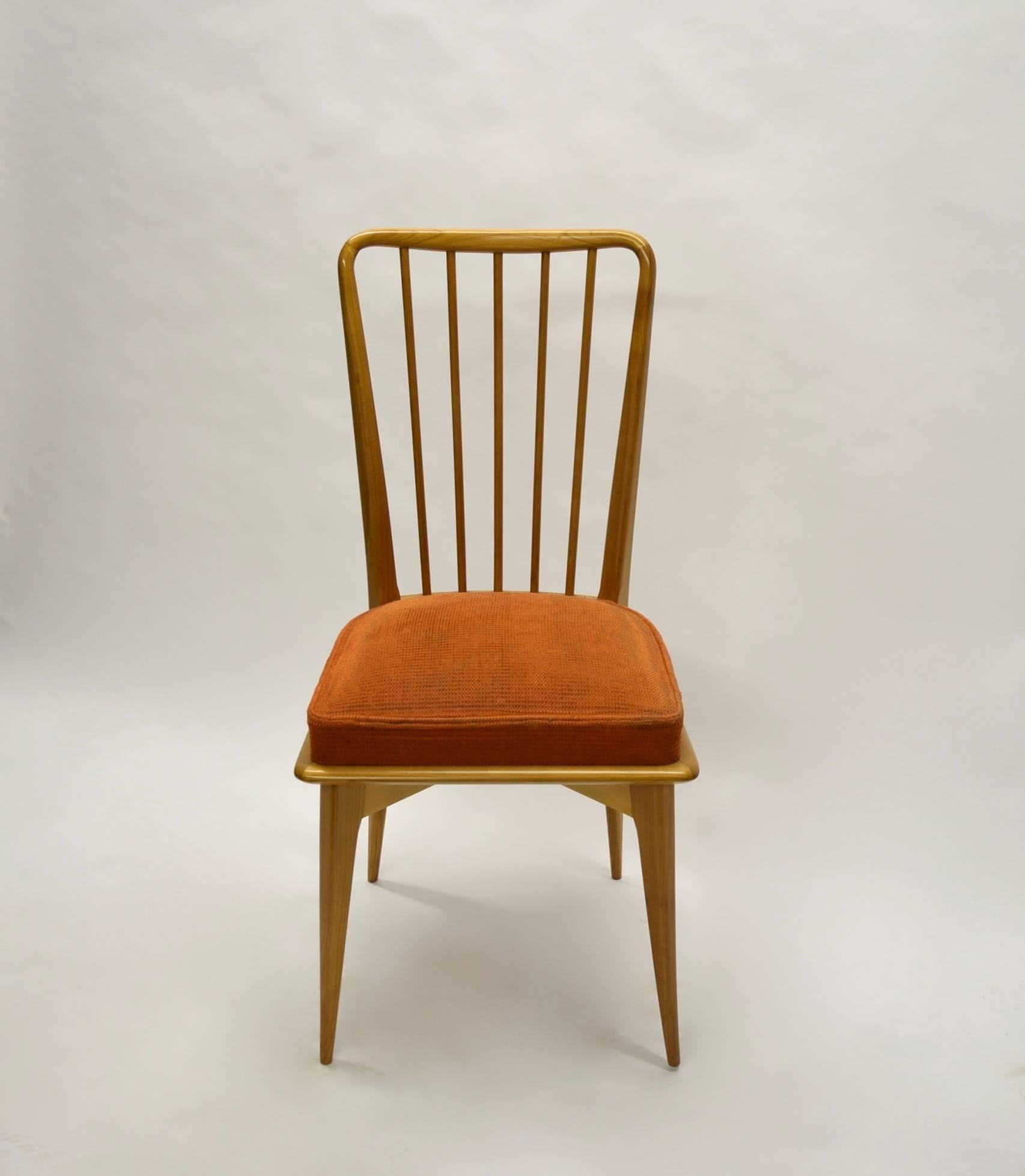 Set of four chairs with great detail; tapered legs and arched apron that support the seat and surrounding bullnose edge. The spindle backs are splayed, rounded and tapered at top and bottom. 