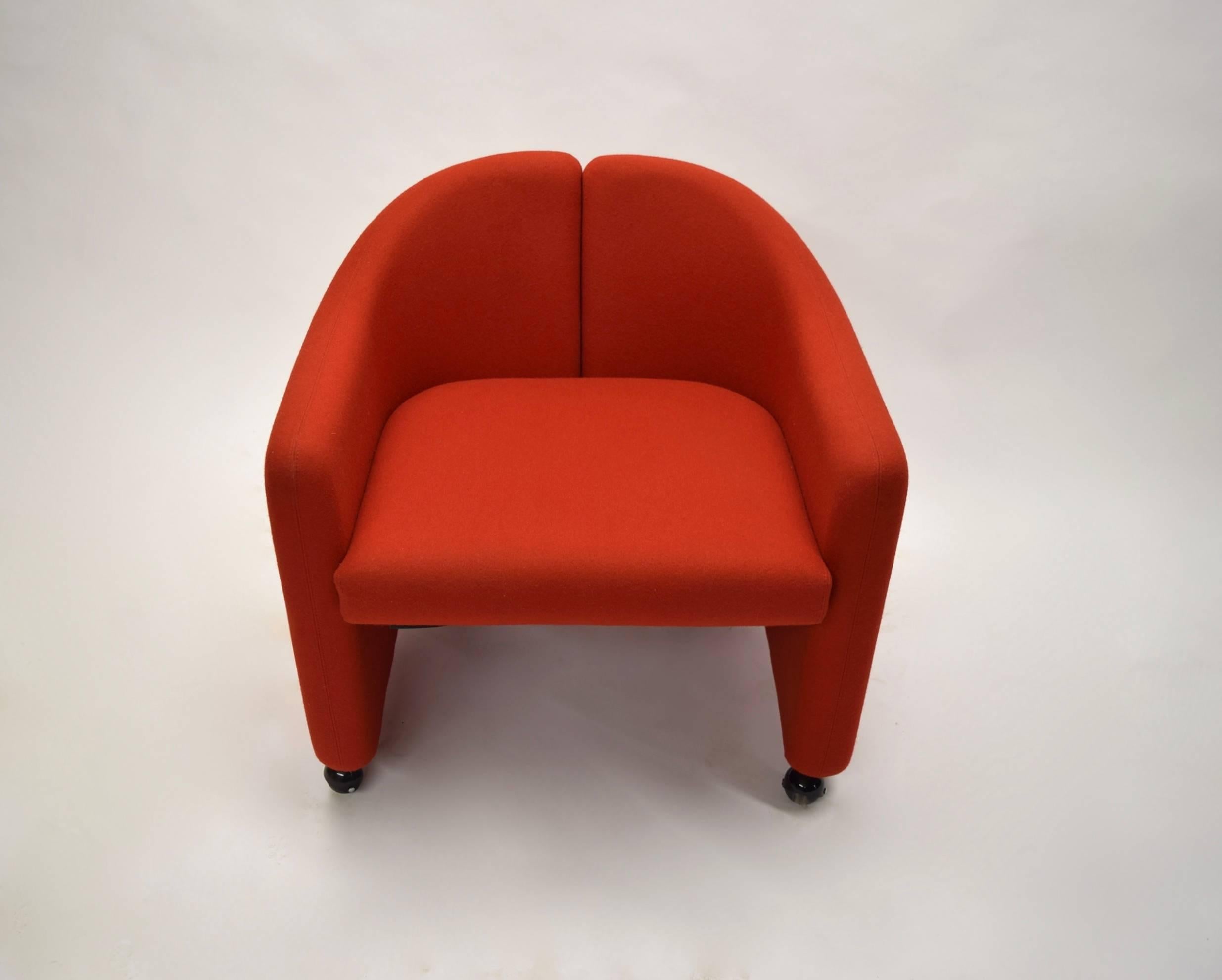 Dining, game or side chairs have a split barrel back an inset seat cushion supporters on four rolling casters. The two chairs have the original stretch red fabric supplied by Racine a French fabric house no longer in production.