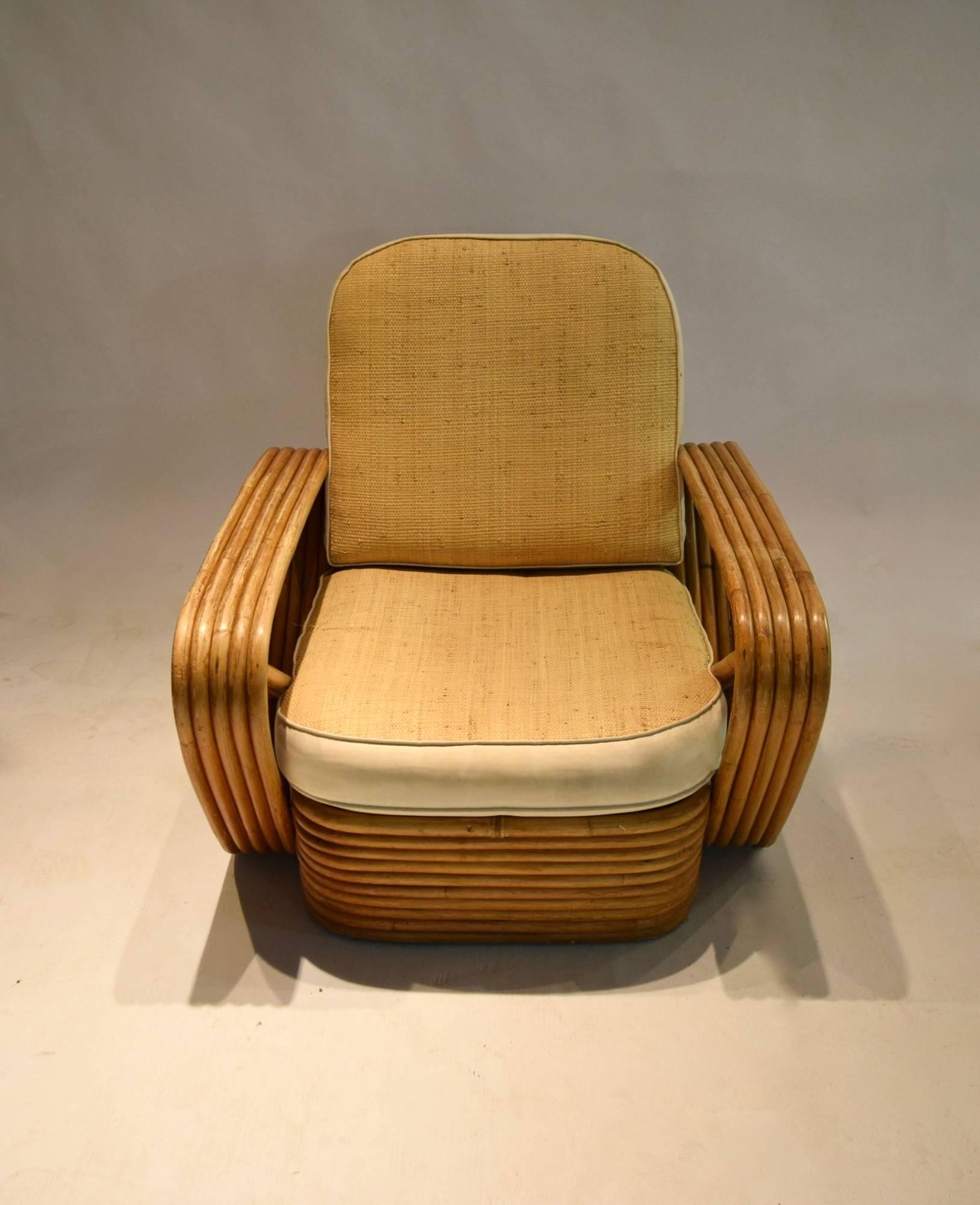 Pair of 5-reed lounge armchairs in very good, original condition with no structural damages, seat and back cushions upholstered in straw woven fabric with bordering and welting in muslin. 
Arm height: 50 cm/19.7