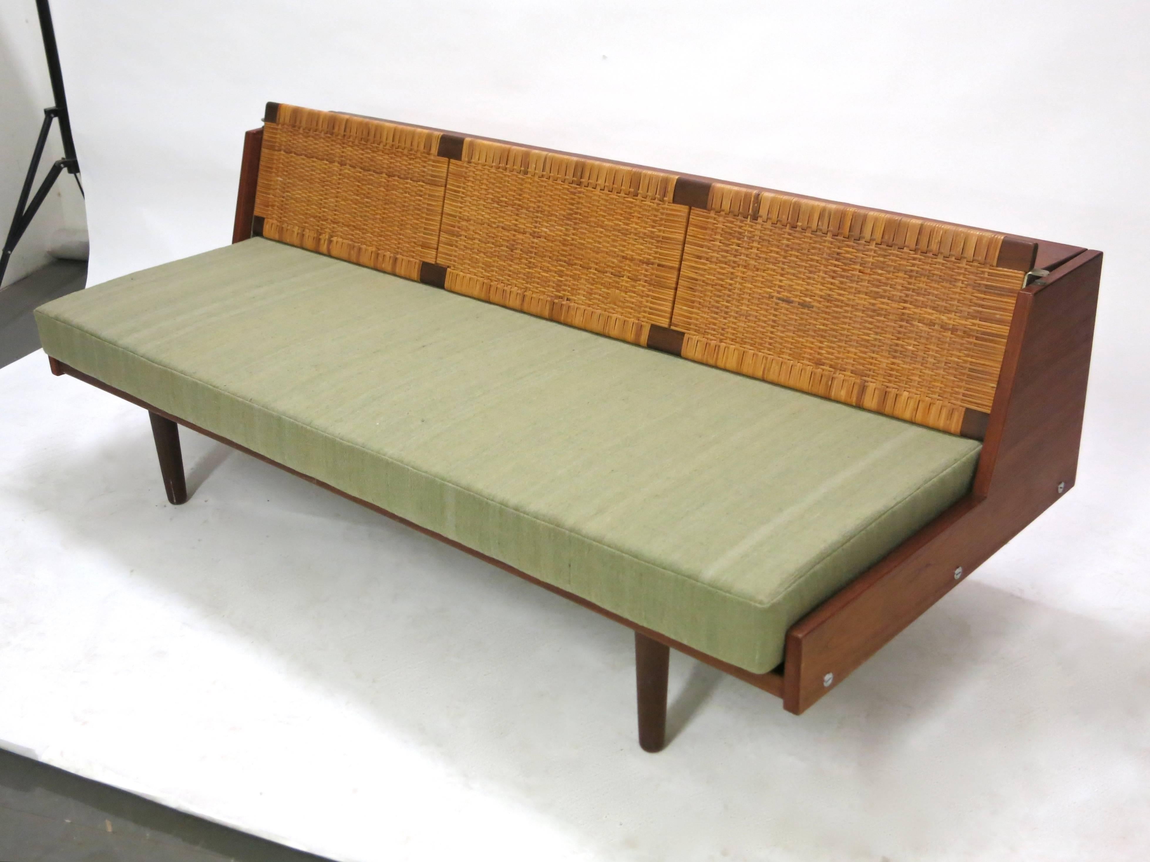 Daybed designed by Hans J. Wegner for Getama in near perfect condition. The woven caned back rest is in original condition, and securely raises up to allow for extra space to sleep or lounge in more comfortably. The cushion has been recently