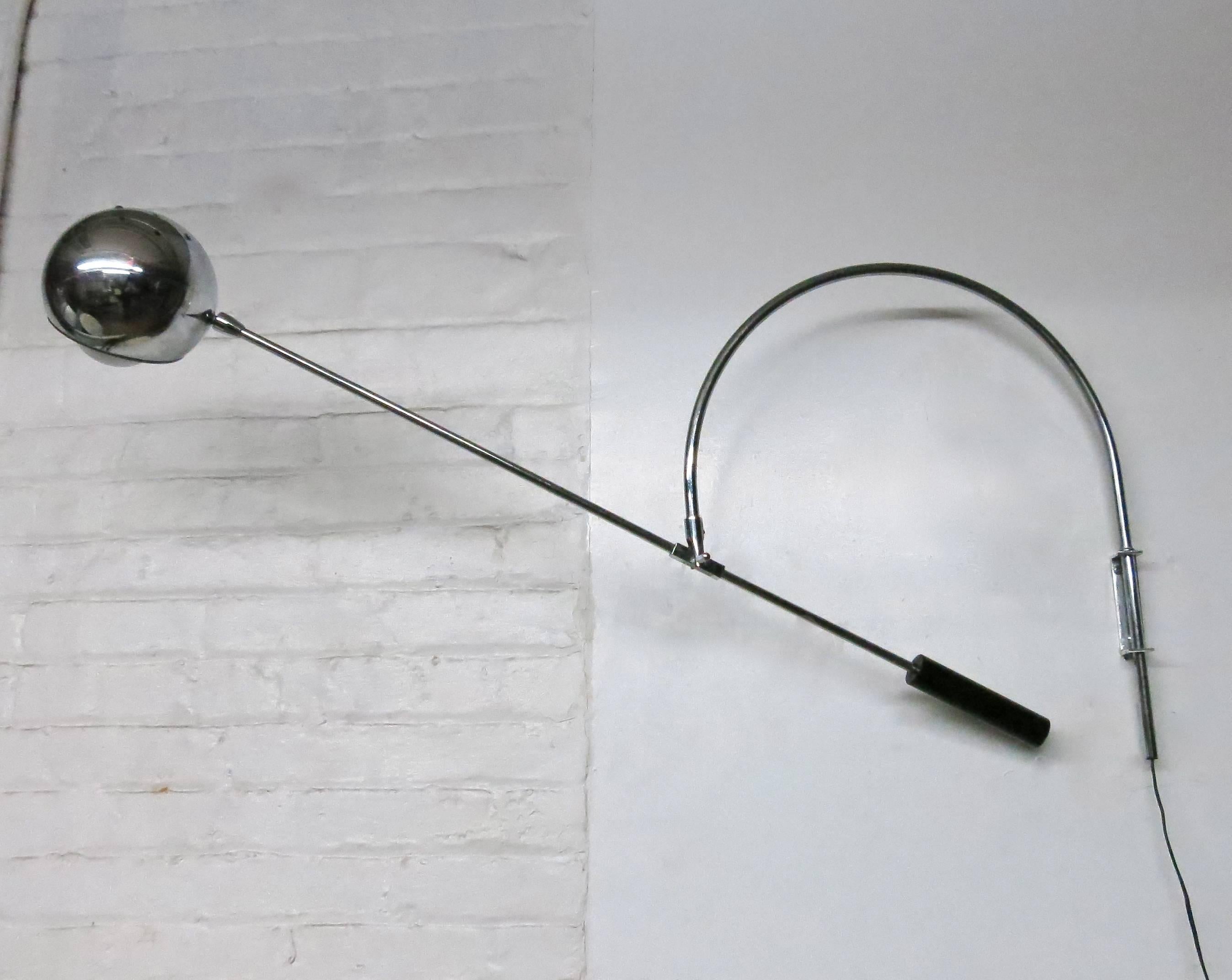 Wall-mounted bracket that holds a tubular steel rod arched at the top that can sway right to left and connects to a straight, counter-balanced arm that moves up and down and side-to-side. The arm has a an articulating light at one end and a counter