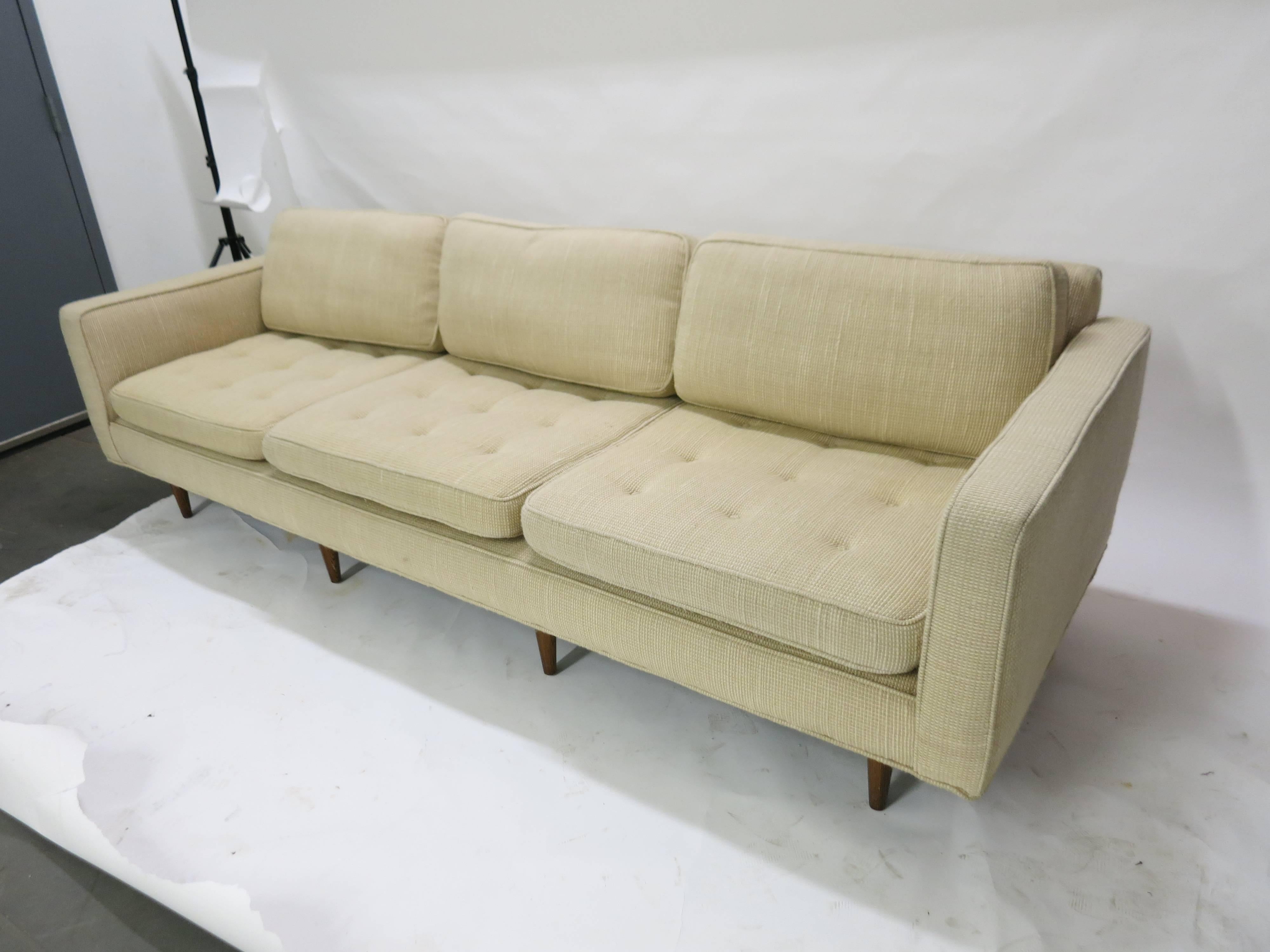 Sofa with three-seat cushions and three back pillow all in, original knoll fabric all supported by eight tapered wood legs. Sofa and fabric are both in great vintage condition and could be used as is. No rips no worn spots and no stains!!!
      