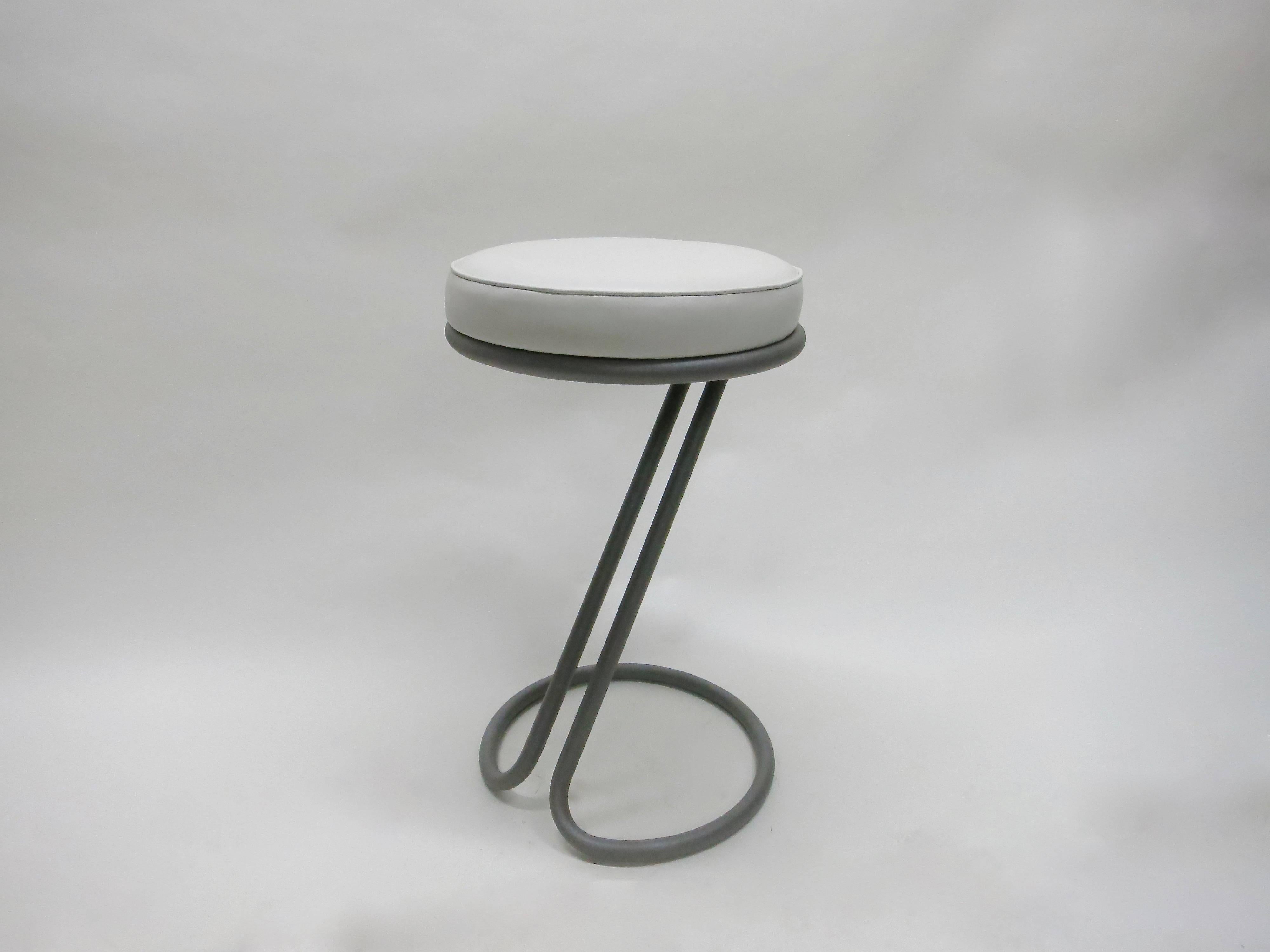 Set of Six Z stools by Gilbert Rhode are all original.  The bases have been sand blasted and powder coated with a metallic coat of paint. The seats are covered in white leather with a welting on edge. 