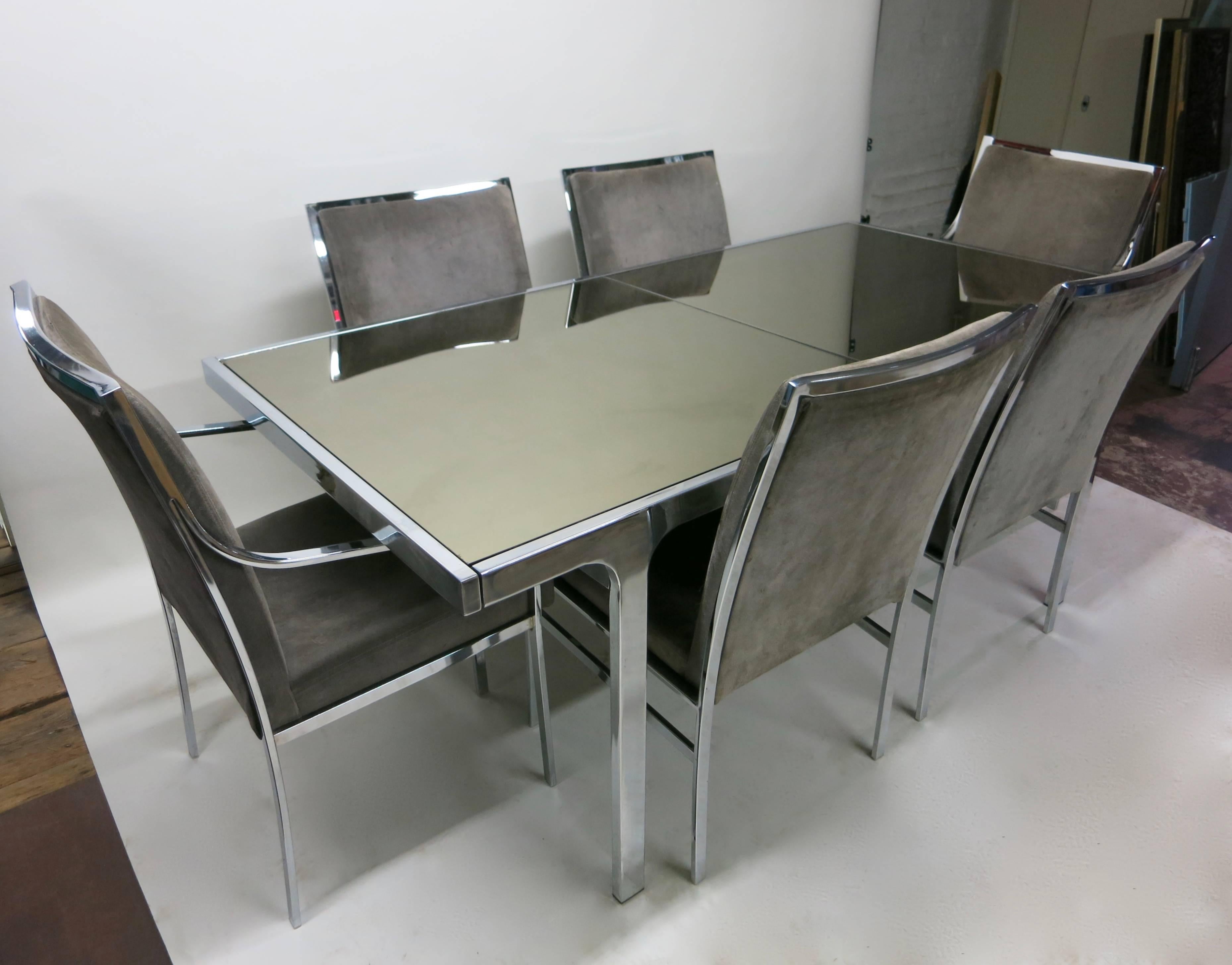 Dining Table with Six chairs designed and signed Pierre Cardin. A mirrored glass and steel table with built in single leaf extension that stows under the top.
The sleek set of chrome chairs has been with the table since original purchase in 1977.