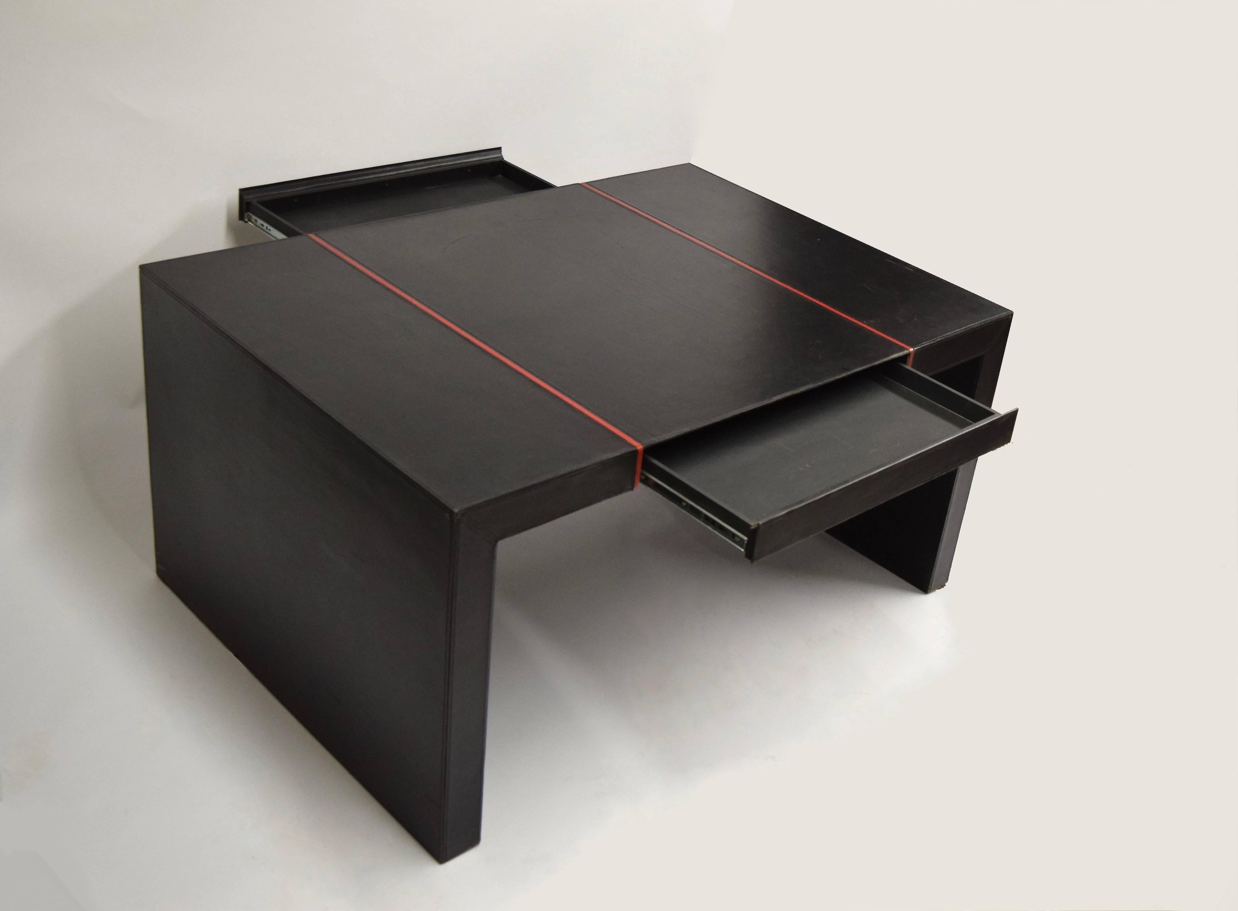 Partners desk in black leather with a red strip on each side. Free standing desk has a 3 1/2 inch thick frame with concealed drawers centered on both sides.