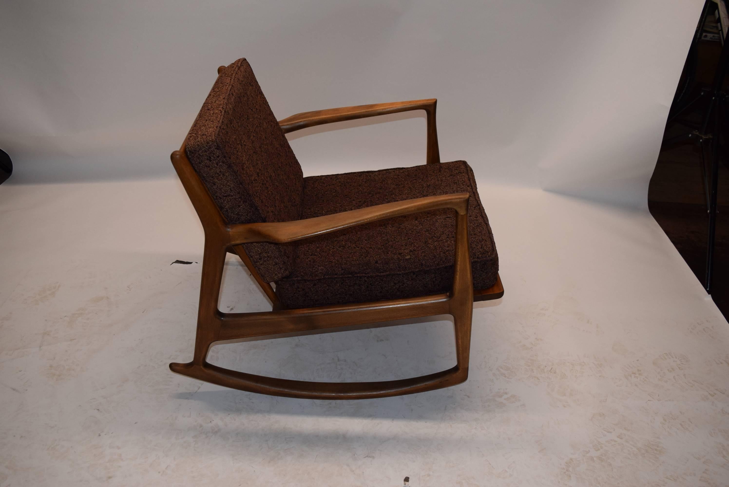 Rocking chair by Ib Kofod-Larson has original cushions. The finish 
also original has no dings scratches dents. The cushions have no tears with little
wear but nothing worn through.
  