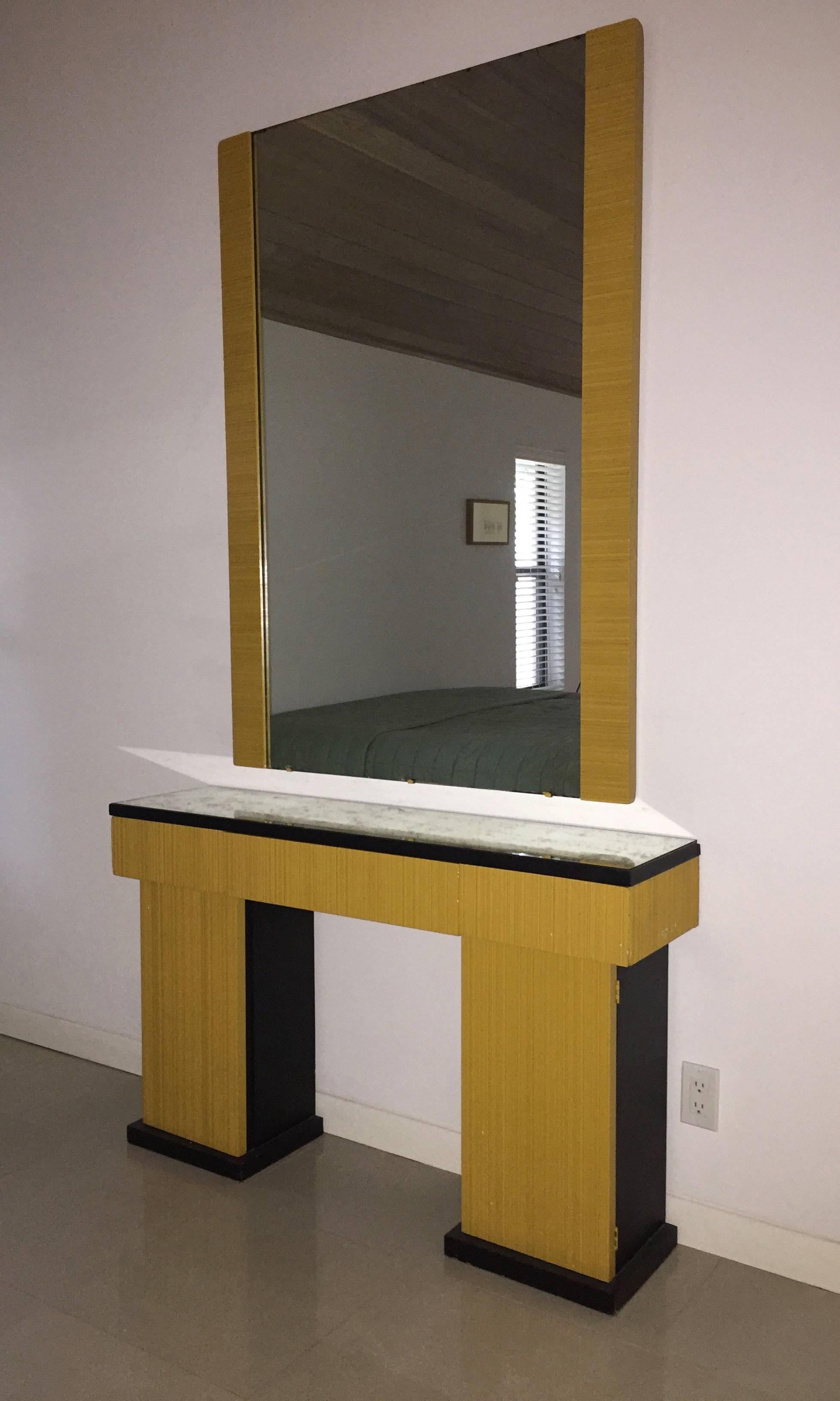 Console has a mirrored top that rests on a row of three drawers, a support at each end both with a single door that opens for storage. 
 The wall mirror has matching yellow lacquered wood on each side and measures 54