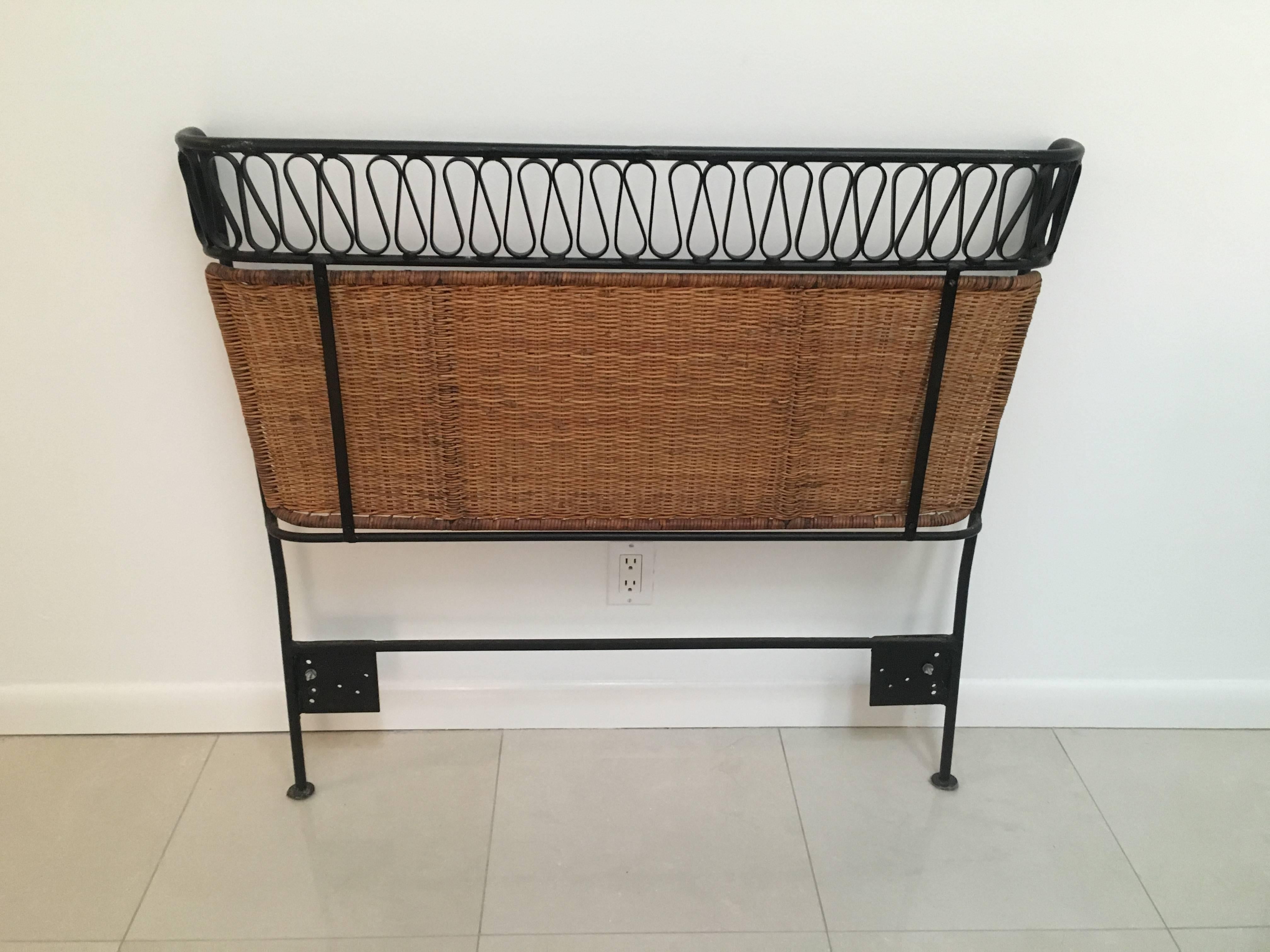 A very rare pair of twin headboards from the "Ribbon Series" of Salterini's modern line that was only produced for a few years in the 1950s.
The enameled wrought Iron tapers out and arches in at the top. Below the ribbon detail is