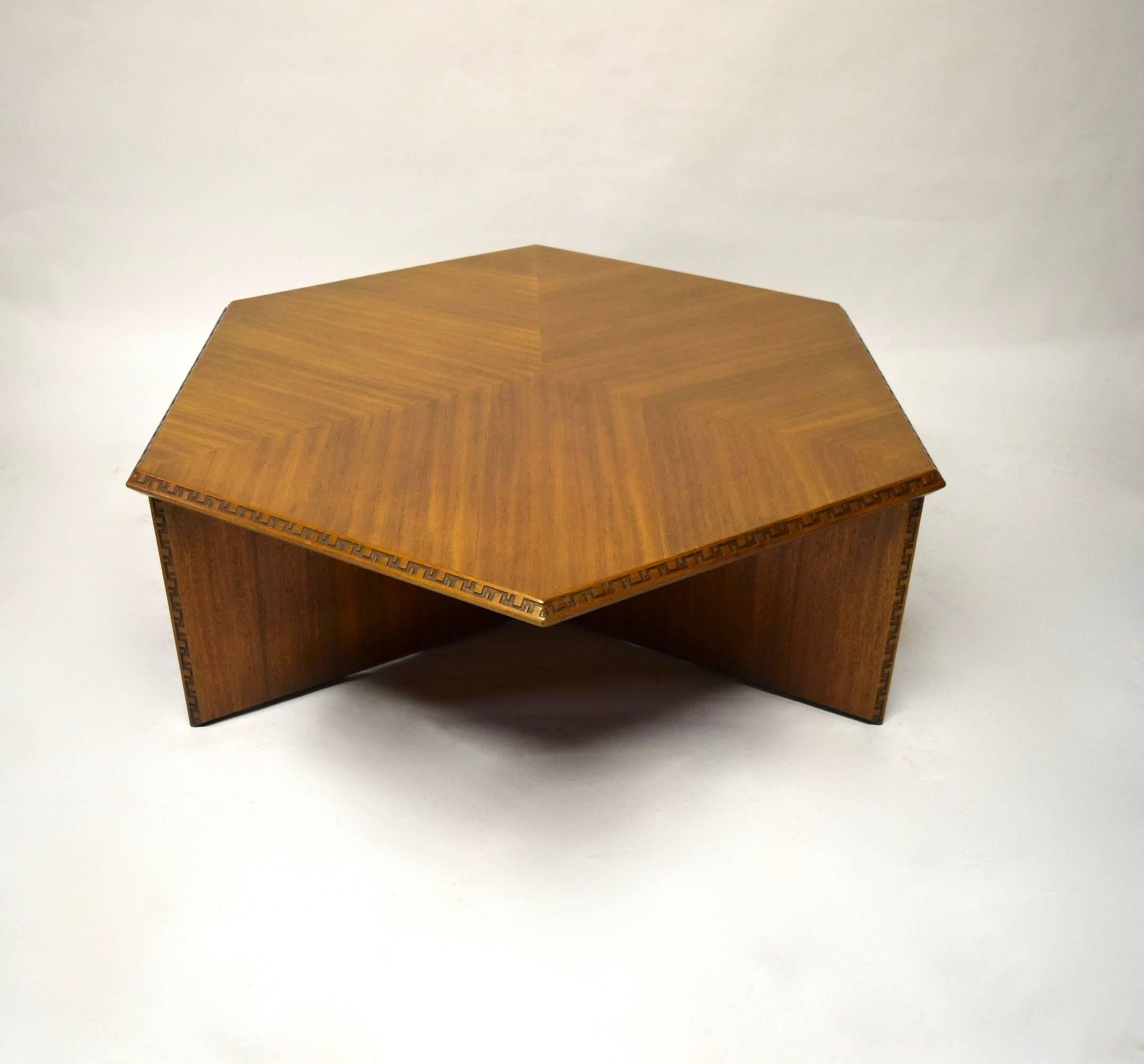 Frank Lloyd Wright six-sided coffee table, 453-3, ion mahogany. The tabletop is six sided with the grain running in four directions. The base has three legs that meet in the center from every other corner. All edges have a Taliesin detail.
Three