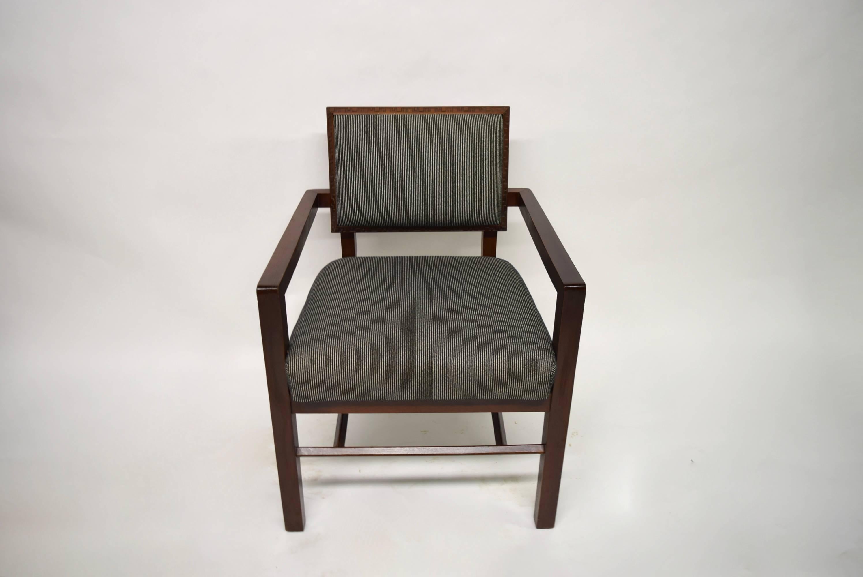 Six side chairs and two armchairs from Frank Lloyd Wright's Taliesin collection for Heritage-Henredon in a mahogany frame and upholstered black and cream vertically striped woven fabric, 1973. 
Armchair measurements: 31.75