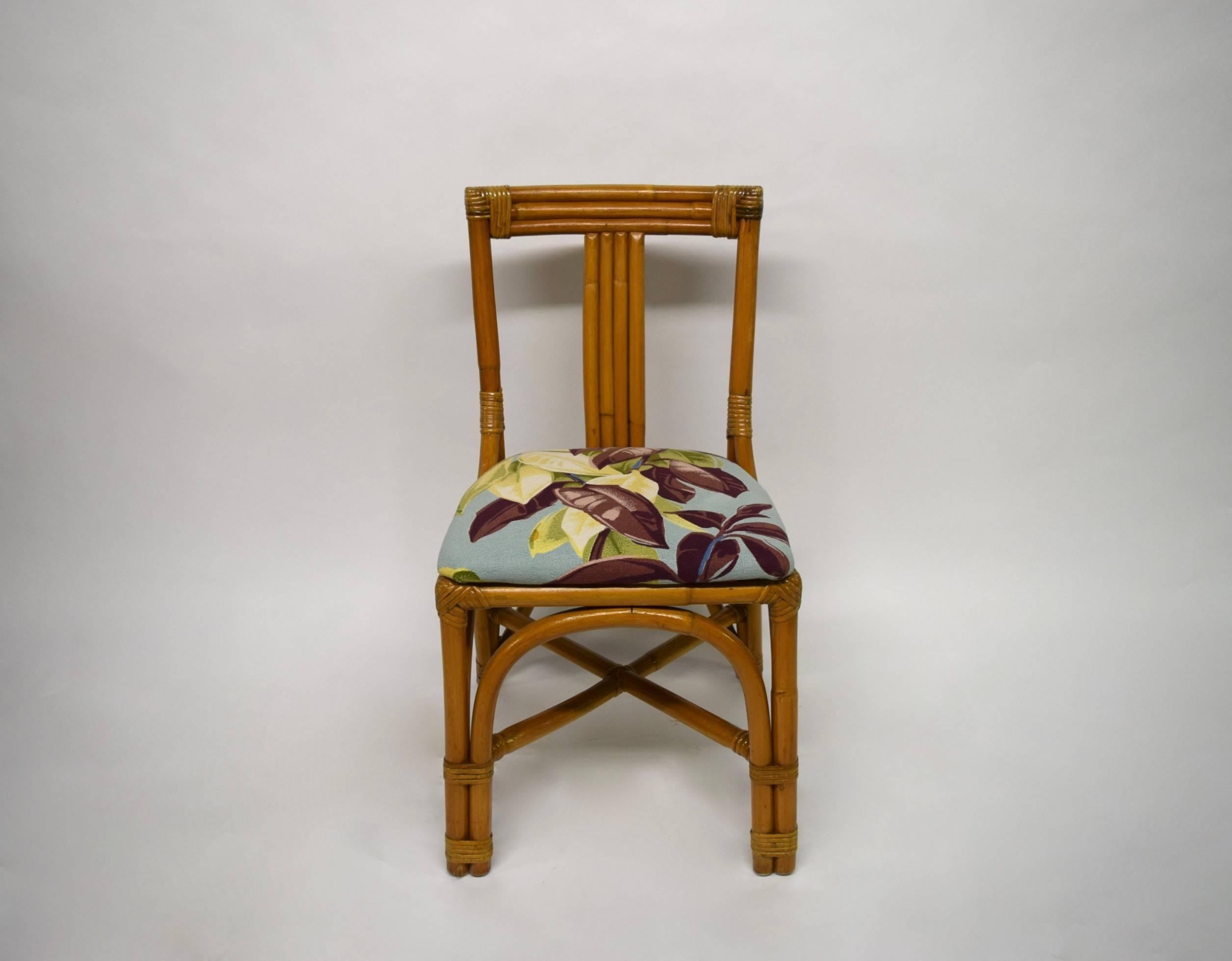 Four bamboo dining height chairs in very good condition with upholstered seats in a printed woven French fabric.