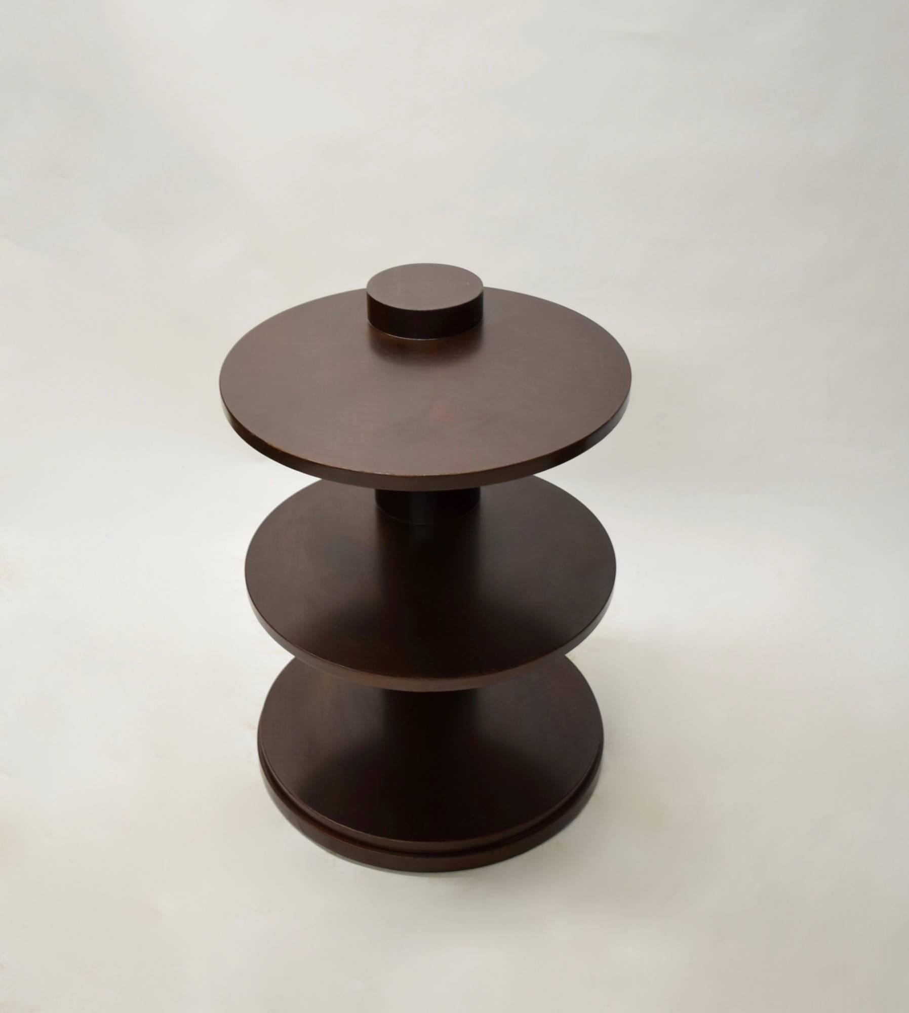 Traditional pair of solid walnut side tables with a dark stained finish by Ralph Lauren. Each table has three round shelves and a single round column that supports them.