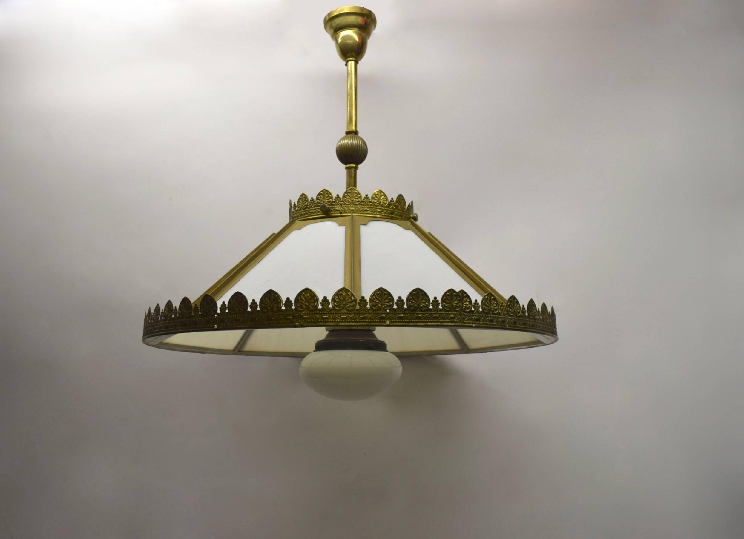 Ceiling fixture from the late 19th century that was originally lit by oil and has been switched to electric current. The fixture has original hardware and canopy, an eight-section exterior shade, encircled with stamped metal trimming, and a