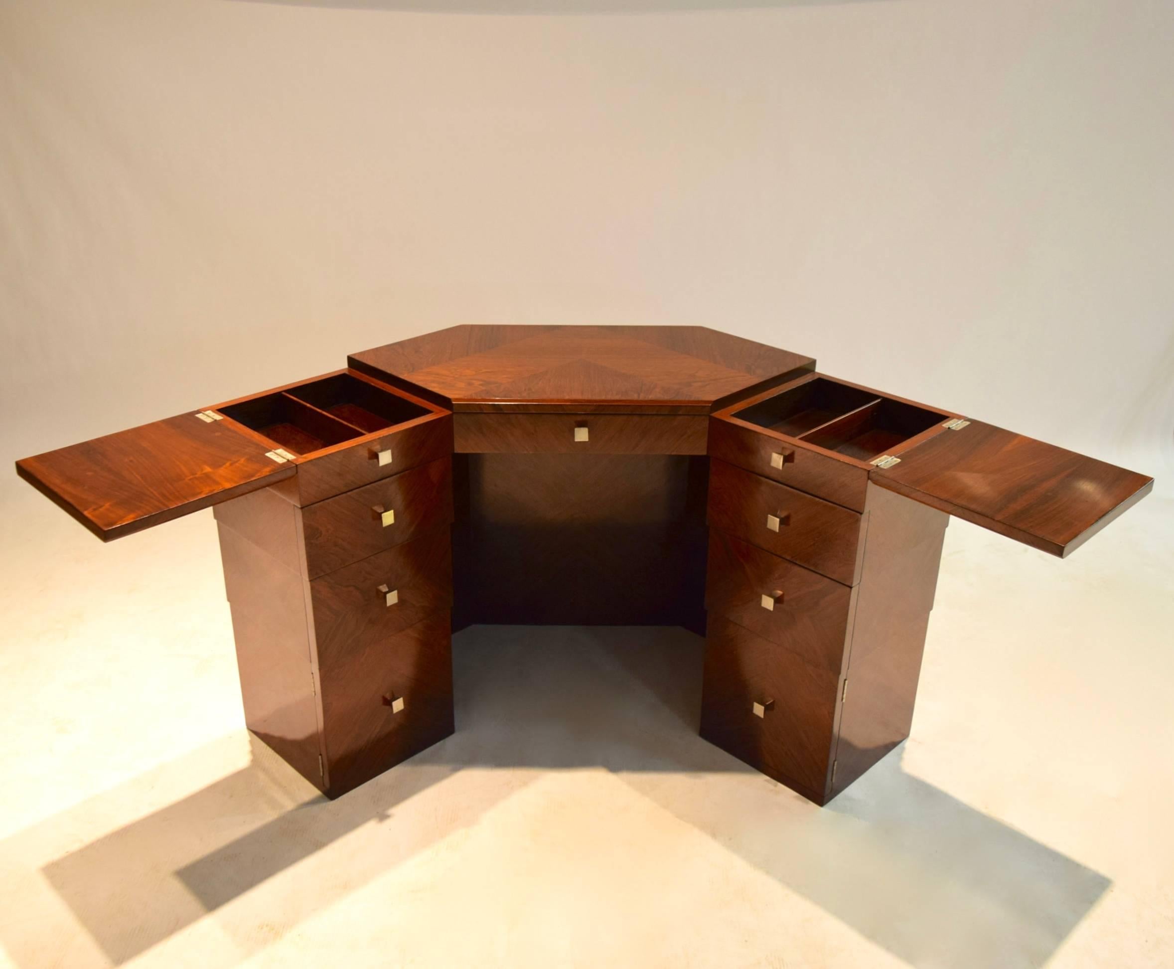Rosewood dressing table for Maison Dominique, that can also serve as a writing table, has one center drawer and drawers symmetrically placed on the right and left sides: a hinged opening on the top adjacent to the hexagonal middle that each reveal a