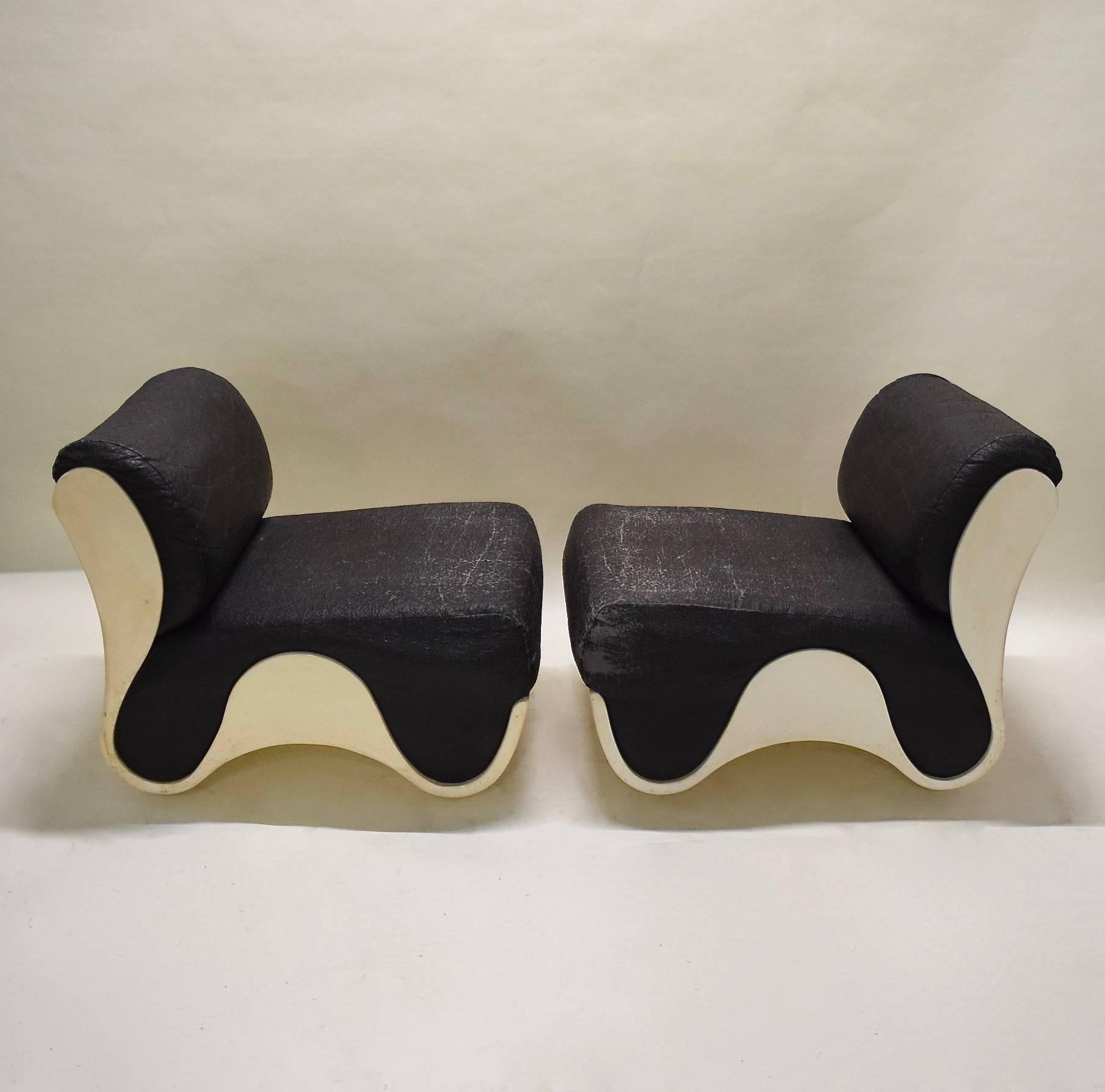 Pair of curvilinear, molded fiberglass framed chairs in great vintage condition with original cushions and black fabric; reupholstery can be provided.