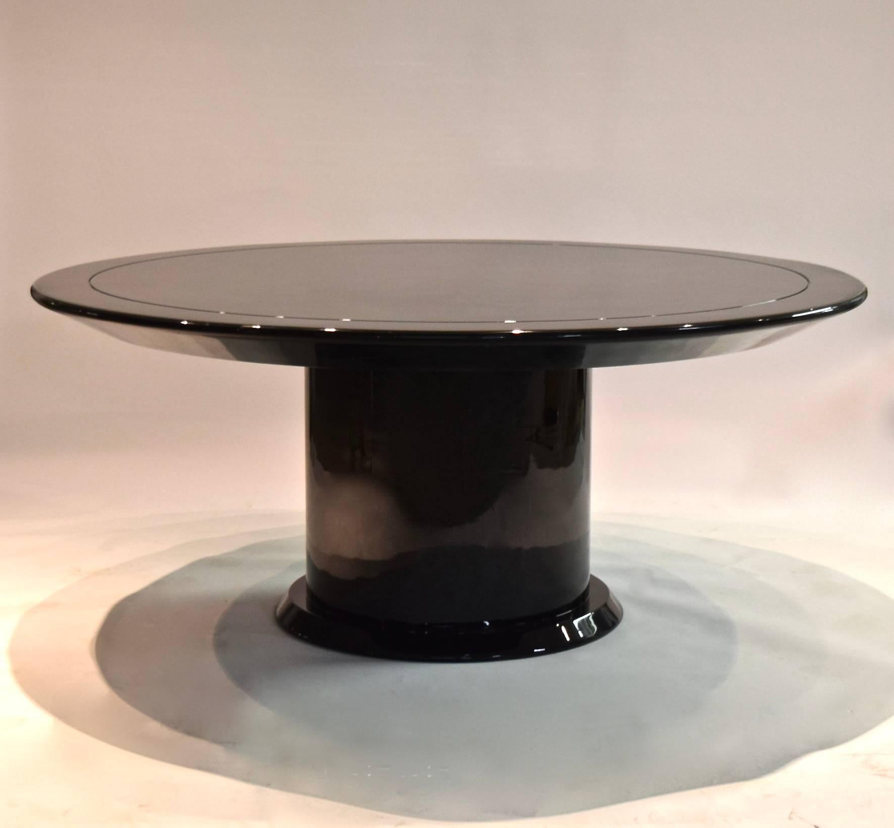 Large scale Table with a round top on a pedestal base finished in a high gloss black lacquer acquired directly from Takashima's flagship location in NYC.
The top has a channeled detail, a 3.75