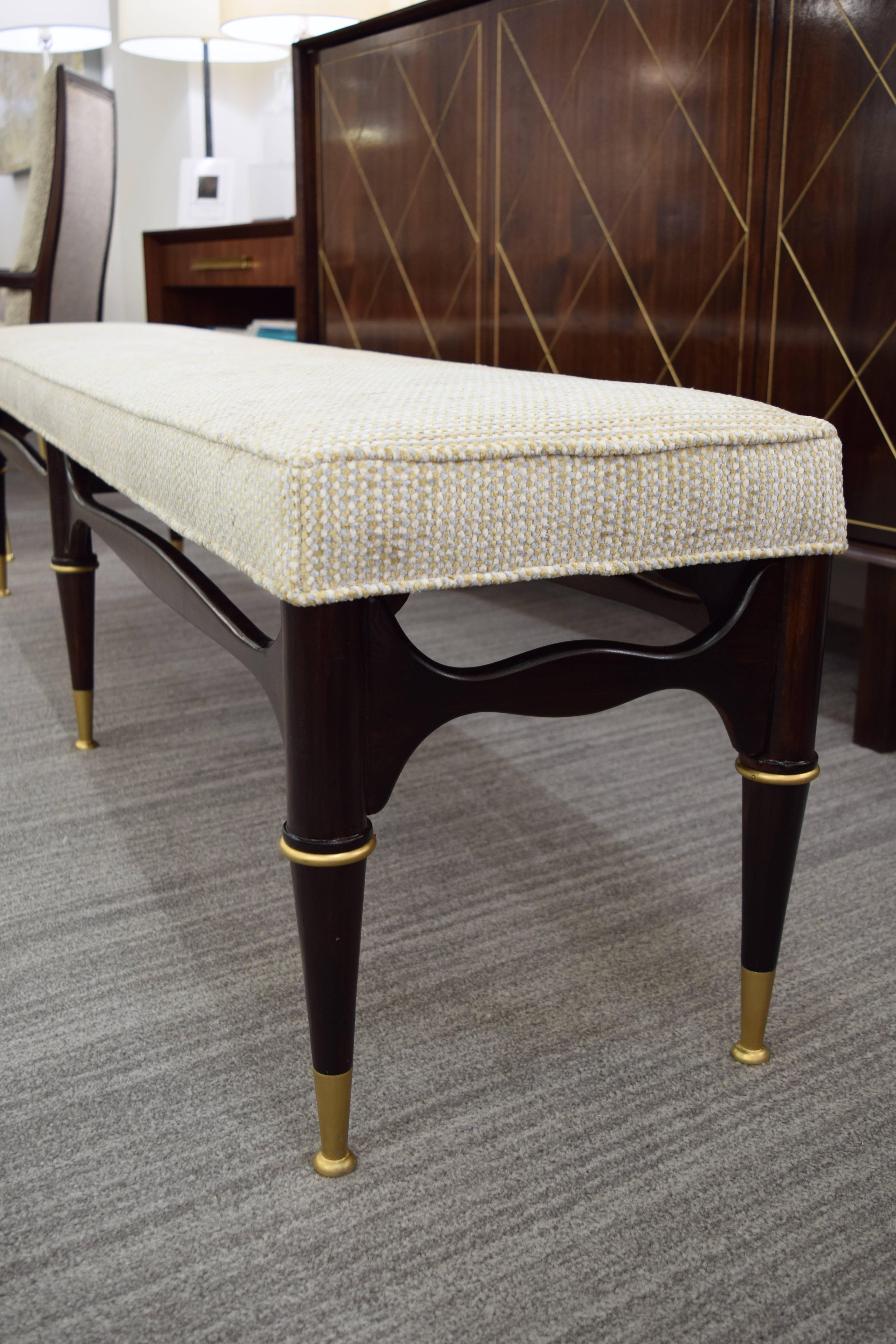 Geo Ponti inspired sculptural  6 leg bench iwth brass accents.  Walnut wood refinished to a deep brown semi gloss fabric.  Topped with neutral chenille with welting details.  
