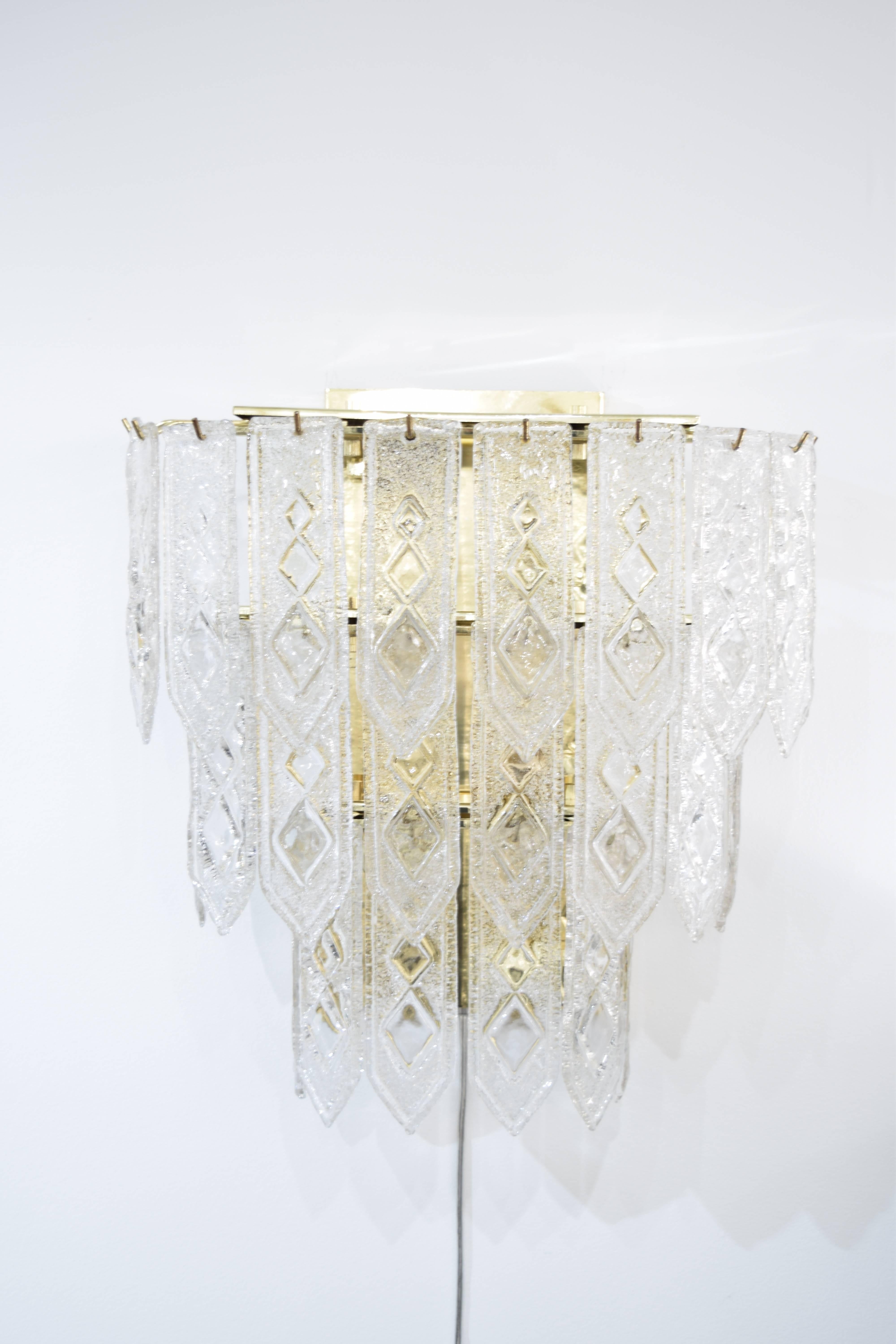 Pair of three-tier blown glass Italian sconces in the style of Venini . Each sconce has 24 crystals that have an Art Deco geometric pattern on them. All crystals in perfect condition. Each sconce holds up to 240 W.