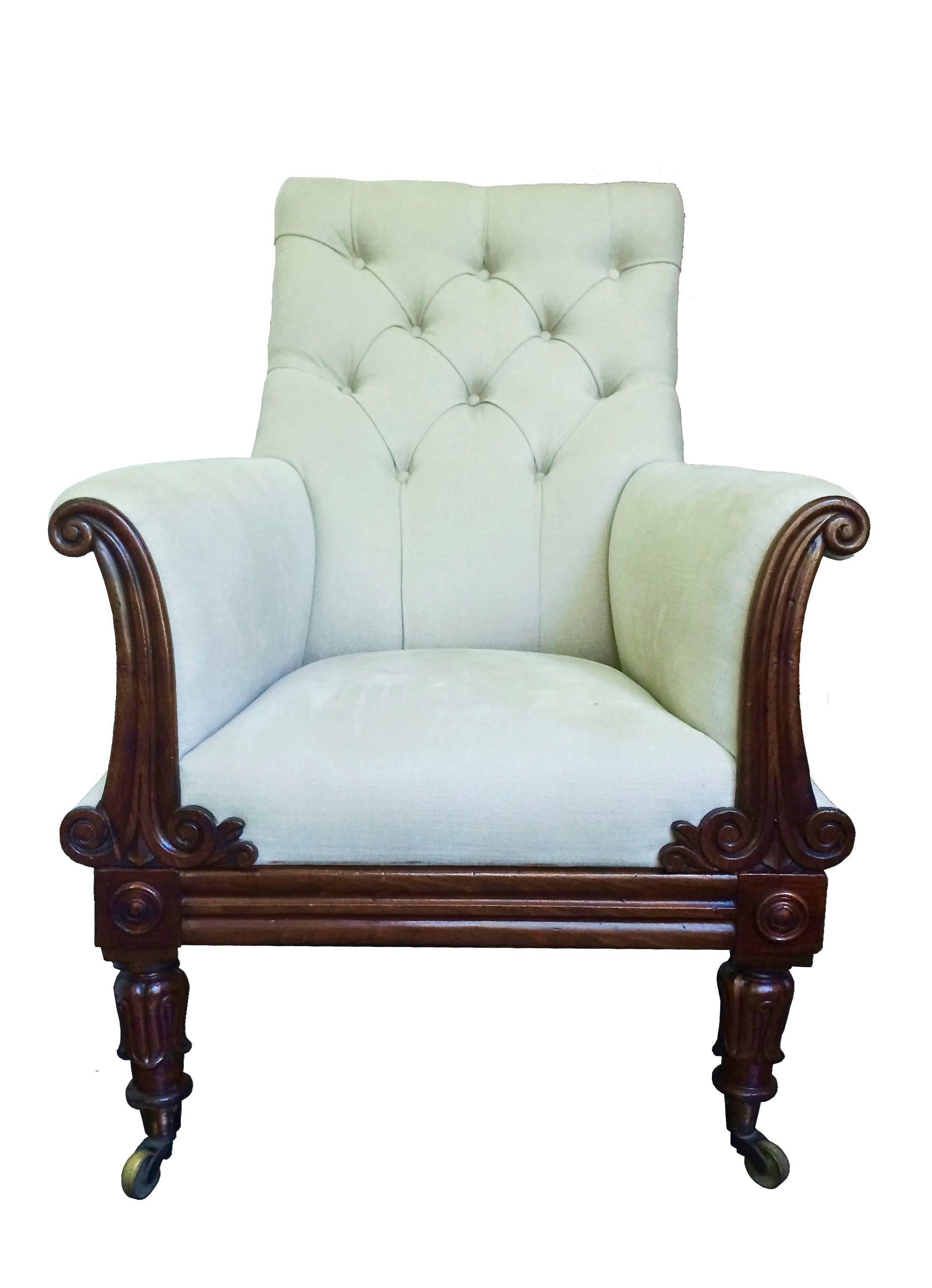 A English Regency library bergere armchair with outscrolled back and 