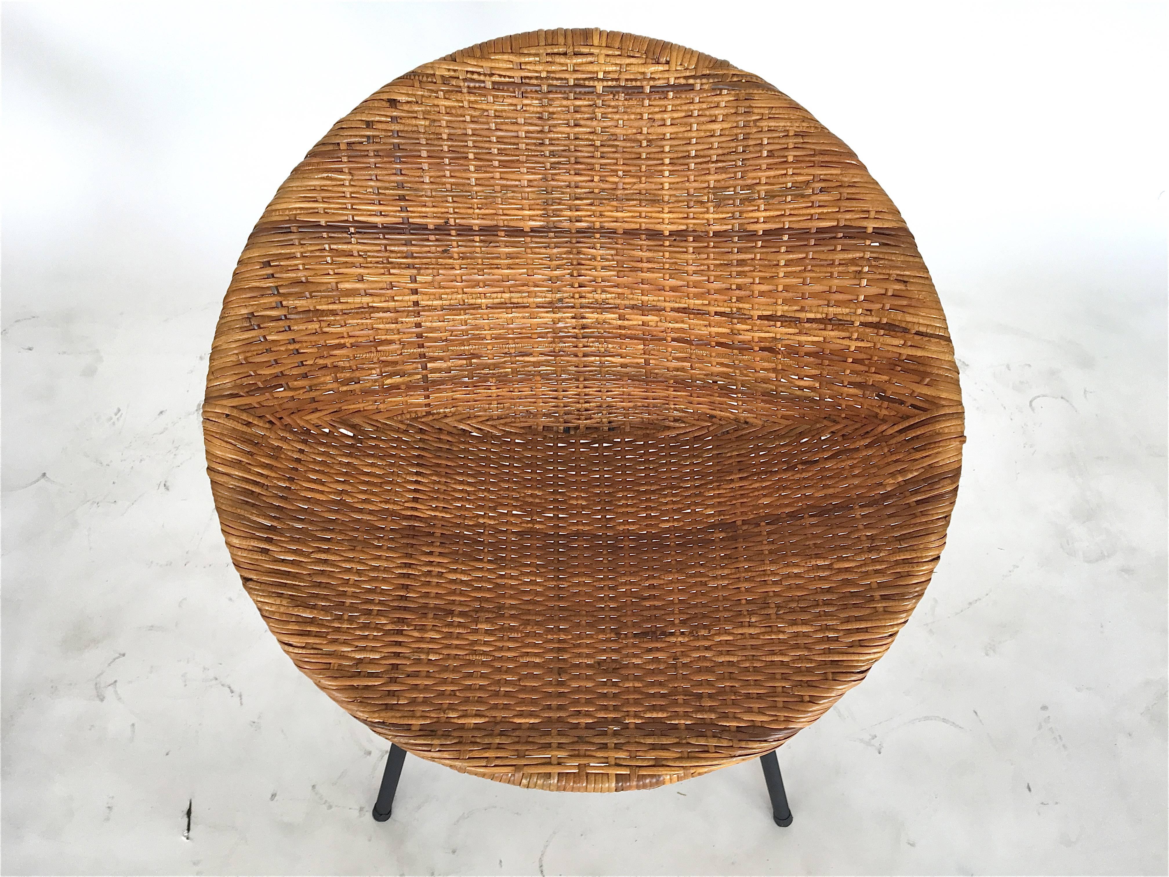 Wonderful wicker and iron scoop bucket chairs. Wicker is in excellent condition. Scooped wicker seat sits on solid iron legs. Perfect for the home or covered outdoor patio. Priced as a pair. Other similar styles available!