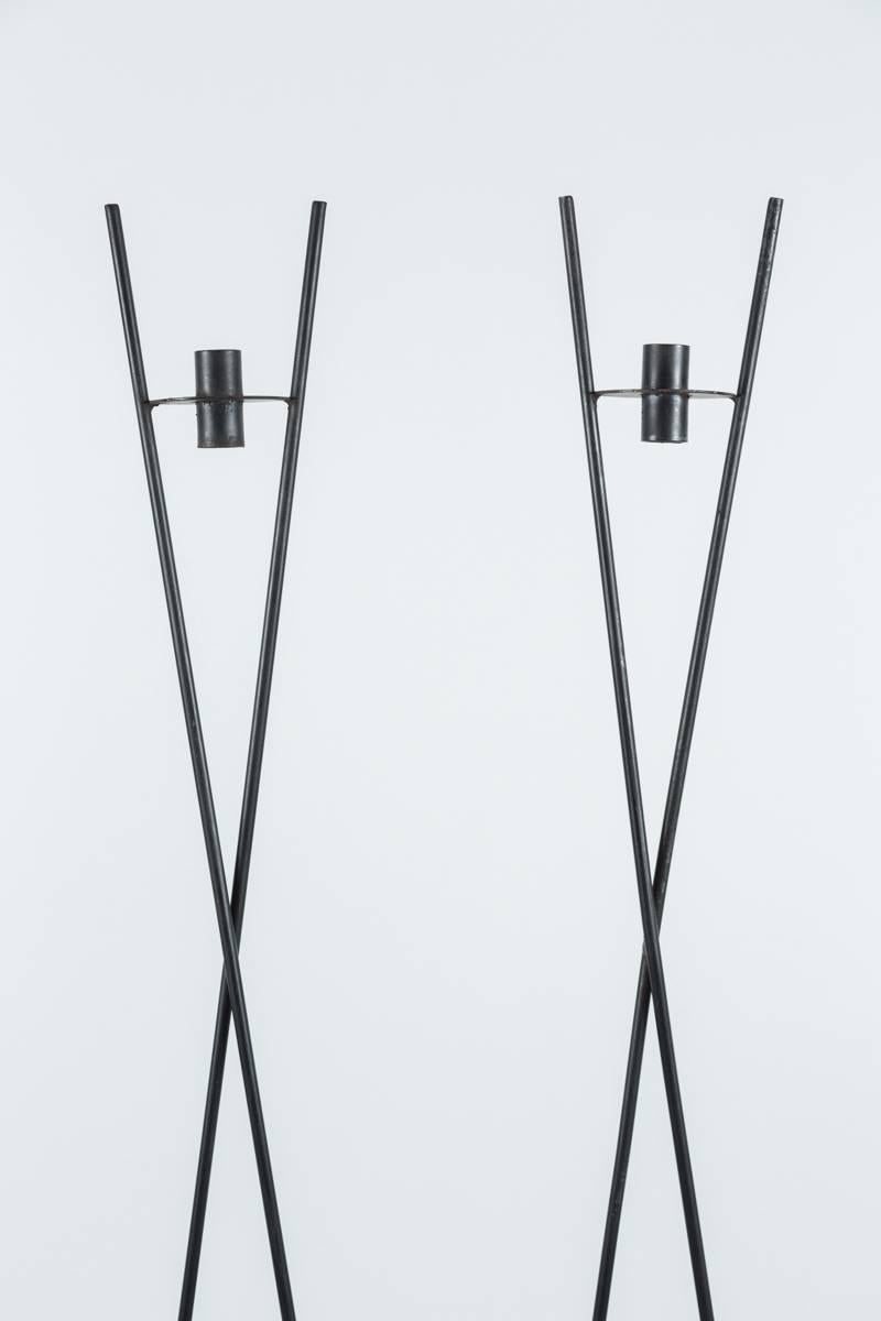 Large-scale iron candleholders in the style of Tommy Parzinger. Sleek elegant addition to any table.