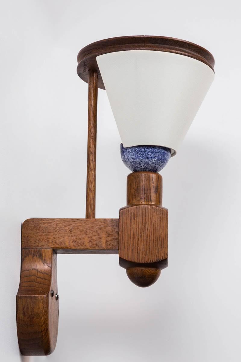 Guillerme et Chambron sconce with original blue ceramic, new silk shade, refinished oak and newly rewired.