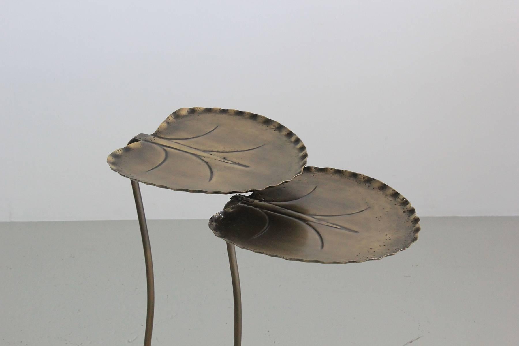Pair of metal lily pad nesting tables designed by John Salterini. One is larger that the other and they nest together. 

Dimensions in listing are for the two tables nestled together. 

Individual dimensions are: 
Large table: H 20 in., D 12.5