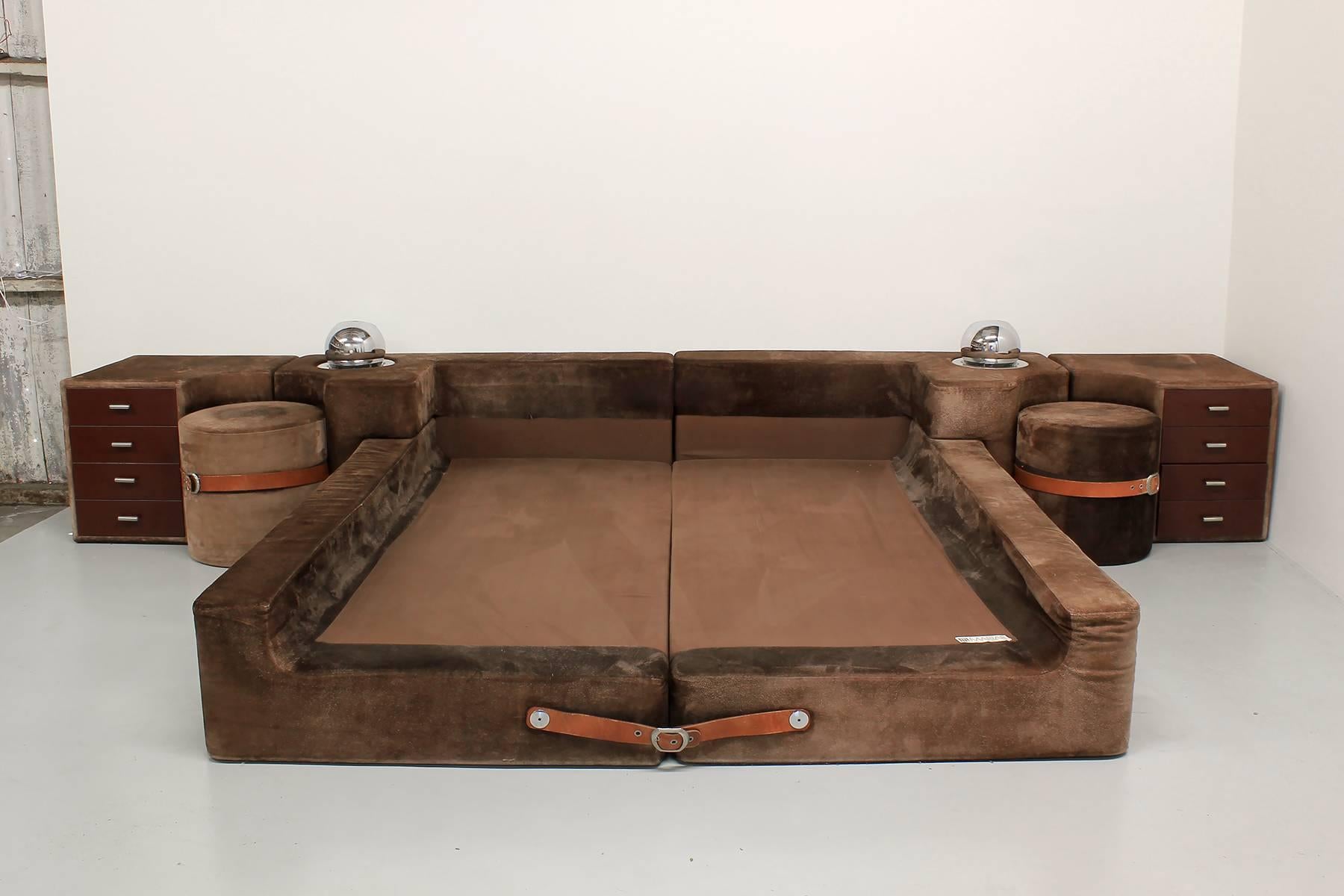 Incredible suede platform bed designed by Guido Faleschini for Mariani, Italy, imported by Pace Collection. Impressively sized with sleek and modern low profile. Finished in rich brown suede with two side tables strapped with original brown leather