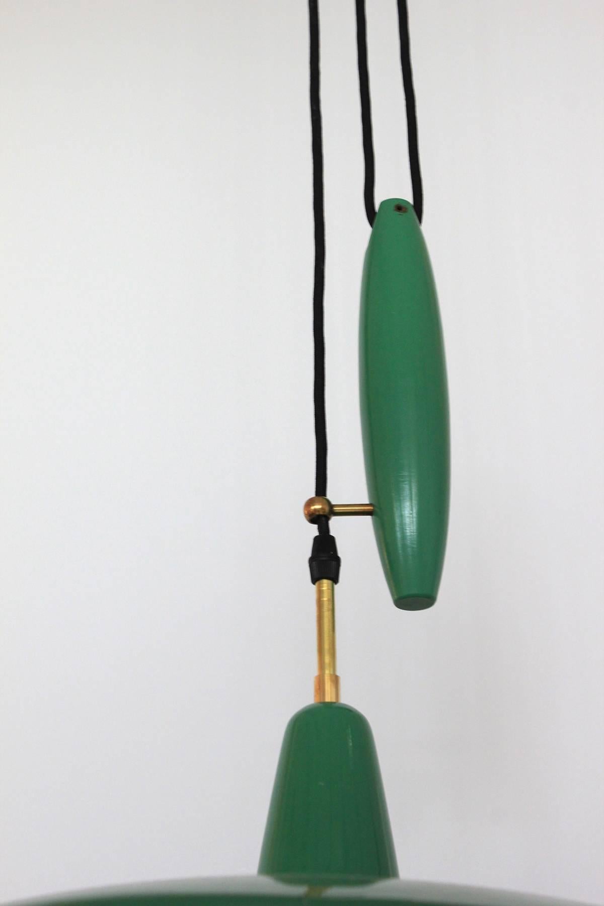 Wonderful Italian counterbalance pendant in original green color. Pulley allows pendant to go up and down with brass loop and brass hardware throughout.