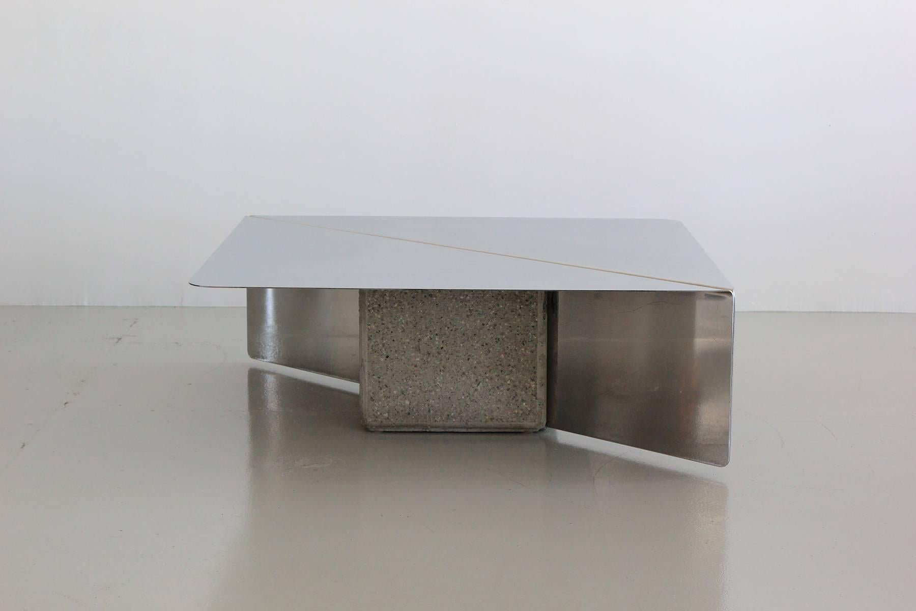 Rare coffee table by Giovanni Offredi for Saporiti comprised of two heavy gauge mirrored stainless steel planes, supported by two cast concrete/stone blocks.
Sculptural and sleek Italian design. 

                 