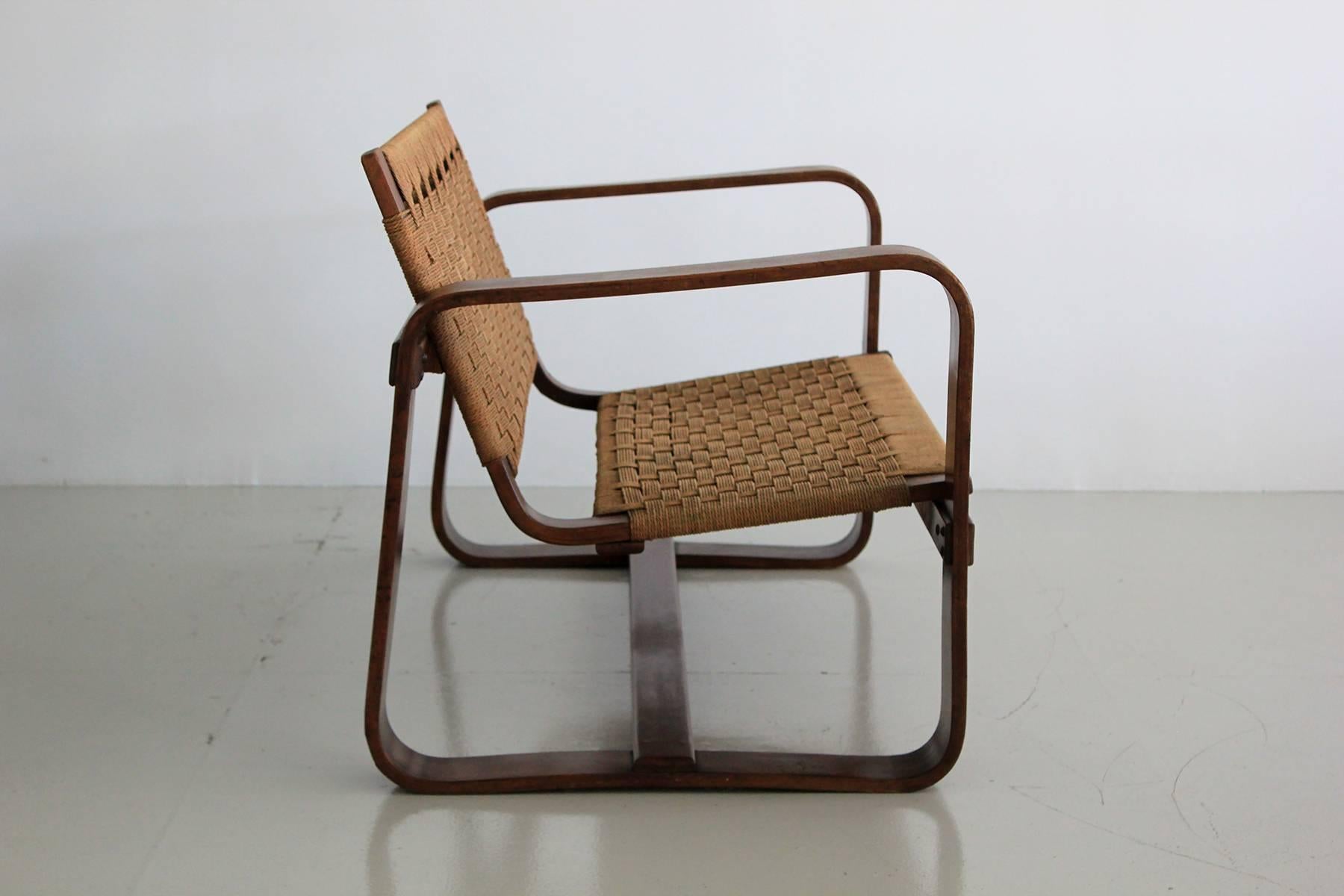 Giuseppe Pagano Pogatschnig. 'Bocconi' two-seat sofa, circa 1939.
Made by Gino Maggioni. 
Beautiful patina on bentwood with cording.

Arm height: 23.5.