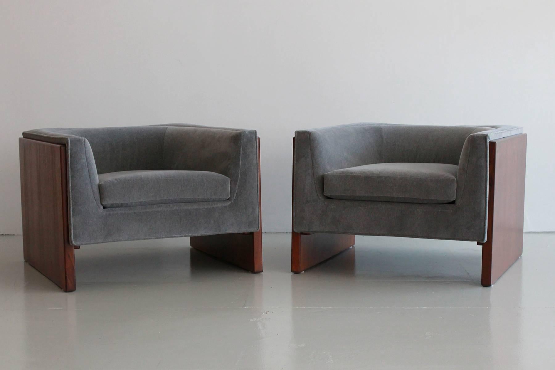 Wonderful pair of cube club chairs by Thayer Coggin attributed to Milo Baughman. Walnut sides create a floating effect and chairs have been refinished and reupholstered in heather grey velvet.