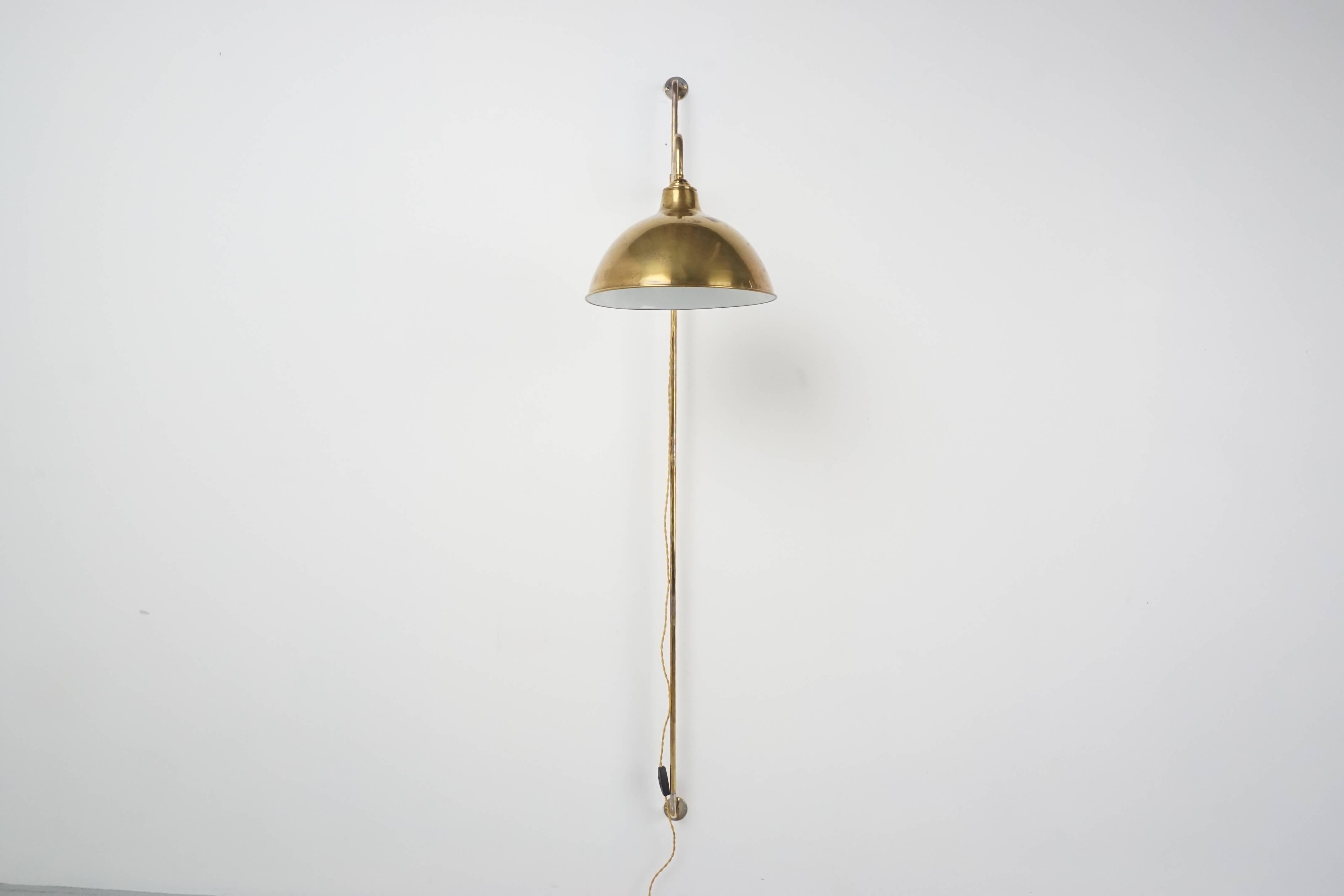 French pole sconce newly produced with a cantilevered arm holding a vintage brass dome shade. Simple, Classic design perfect for any room. 

Two available, priced individually.
